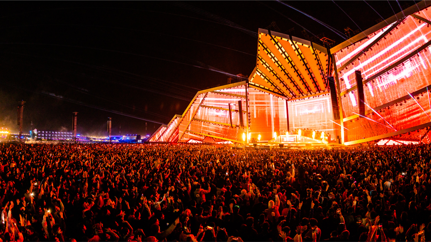 panoramic view of large stage with orange lights taken from audience perspective