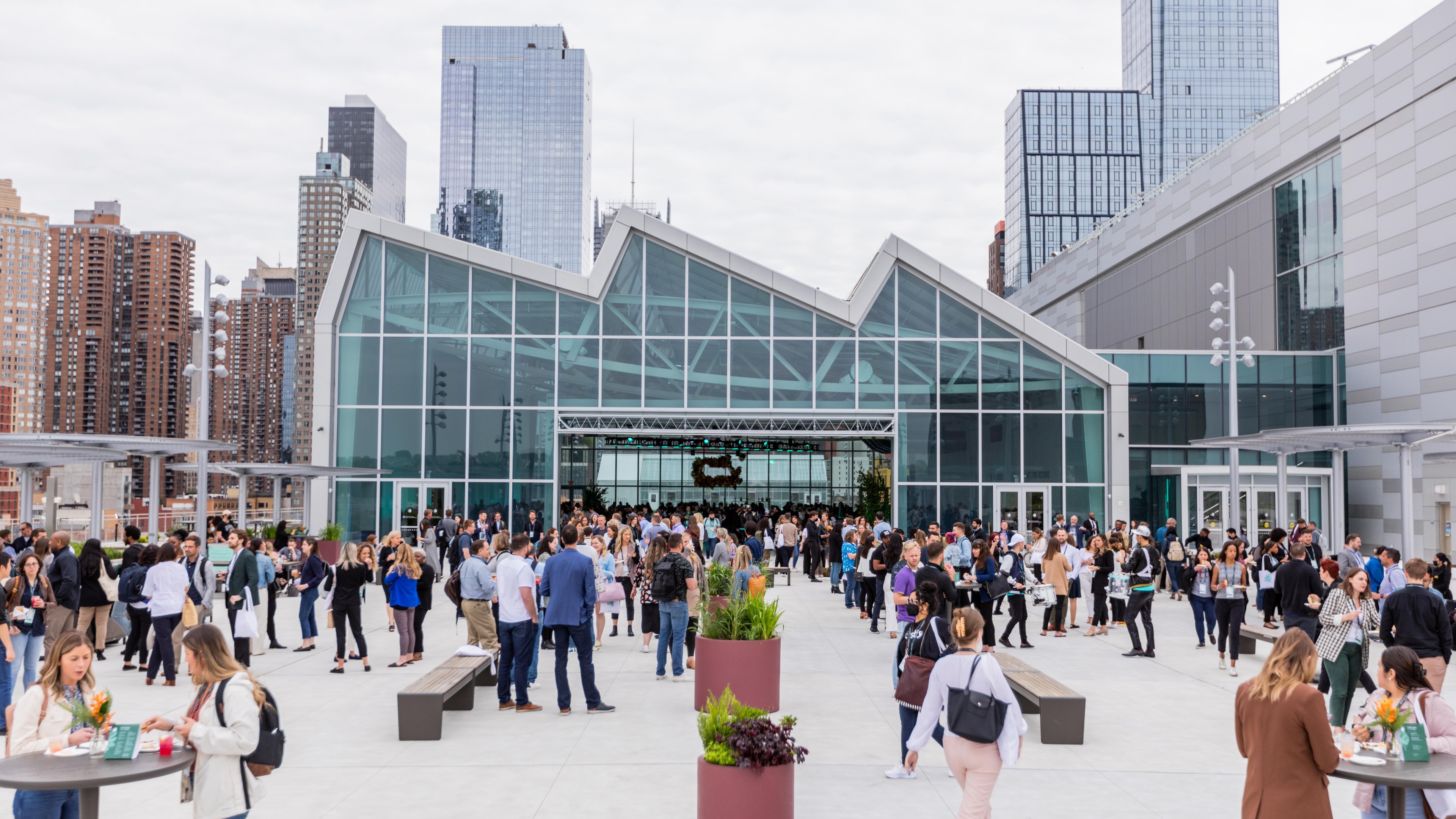 crowd of people walking into glass fronted building