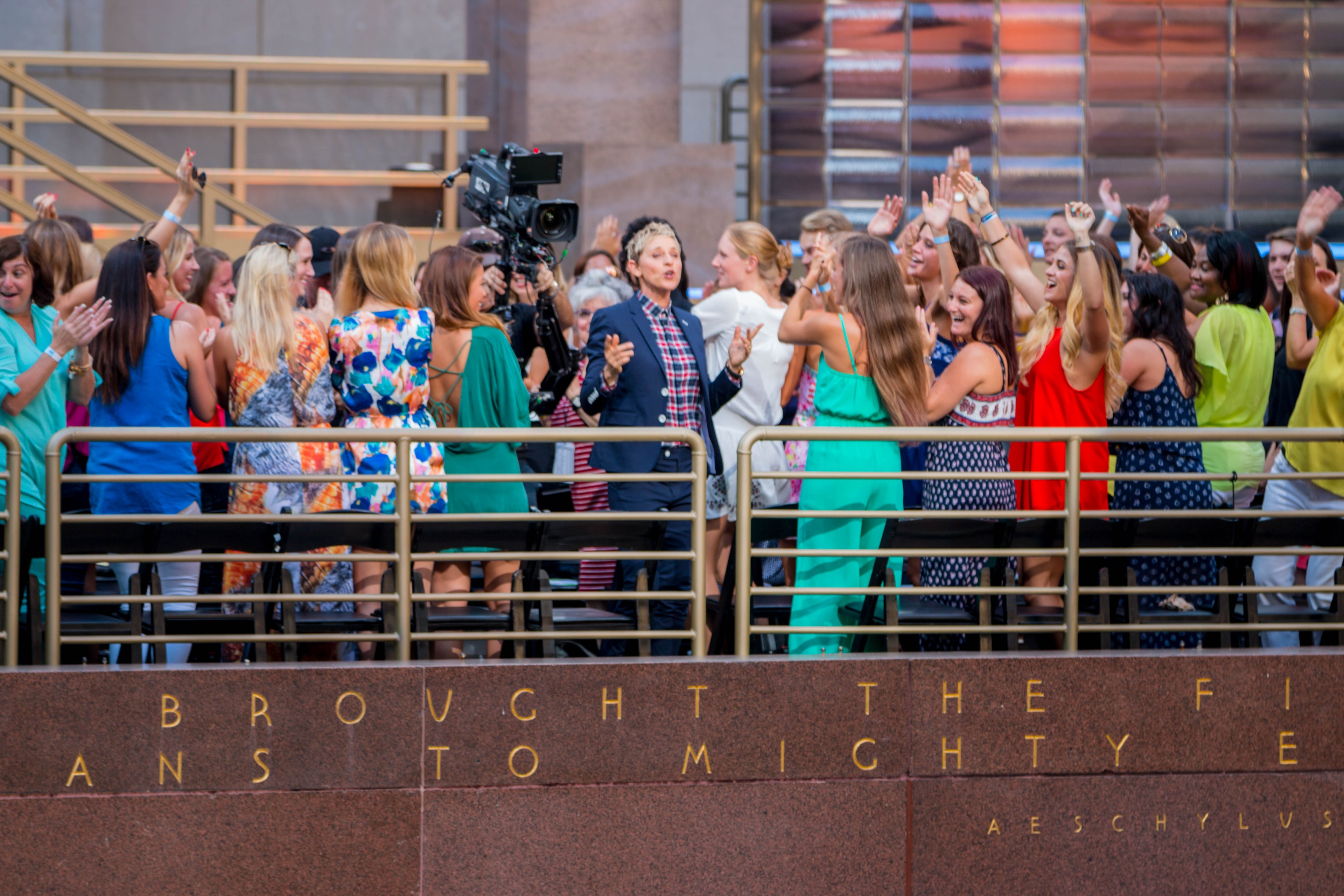 Ellen DeGeneres in center with a crowd of dancing women at the Rockefeller Center