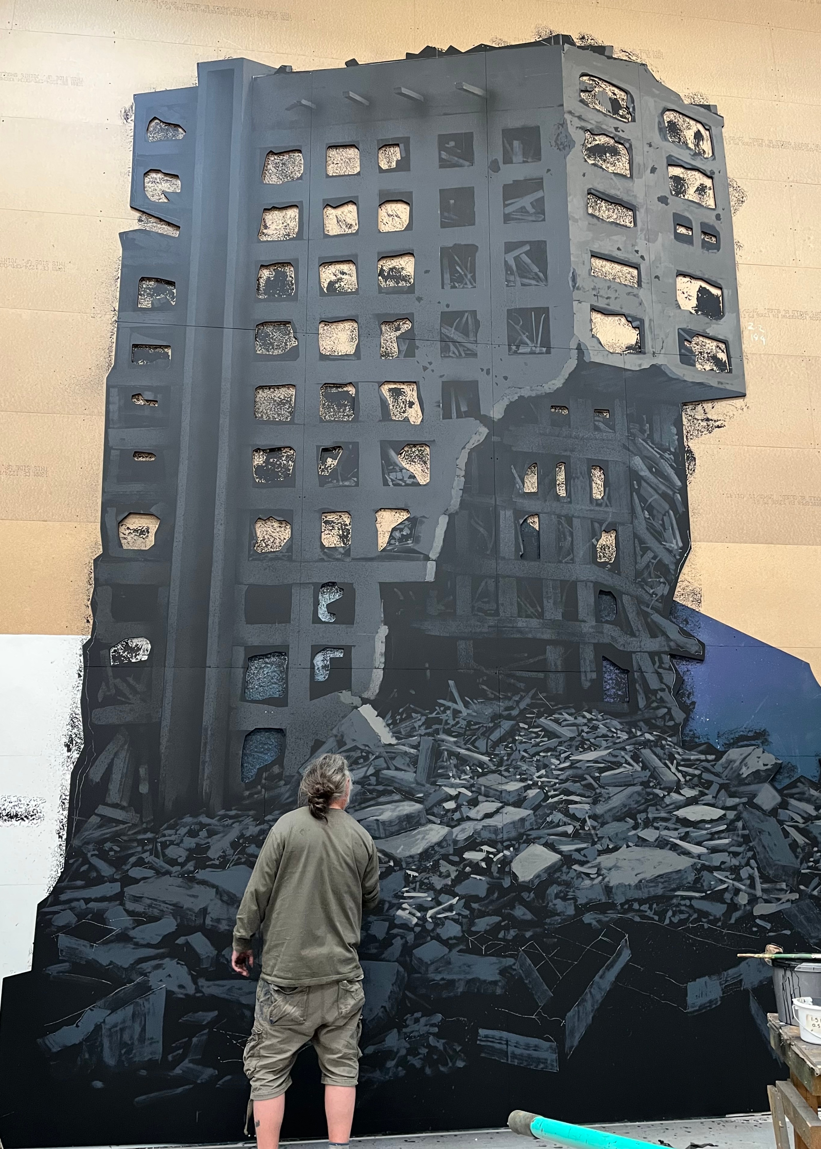 behind the scenes of My Chemical Romance Foundations Tour featuring stage scenery build, male painting a building crumbling down