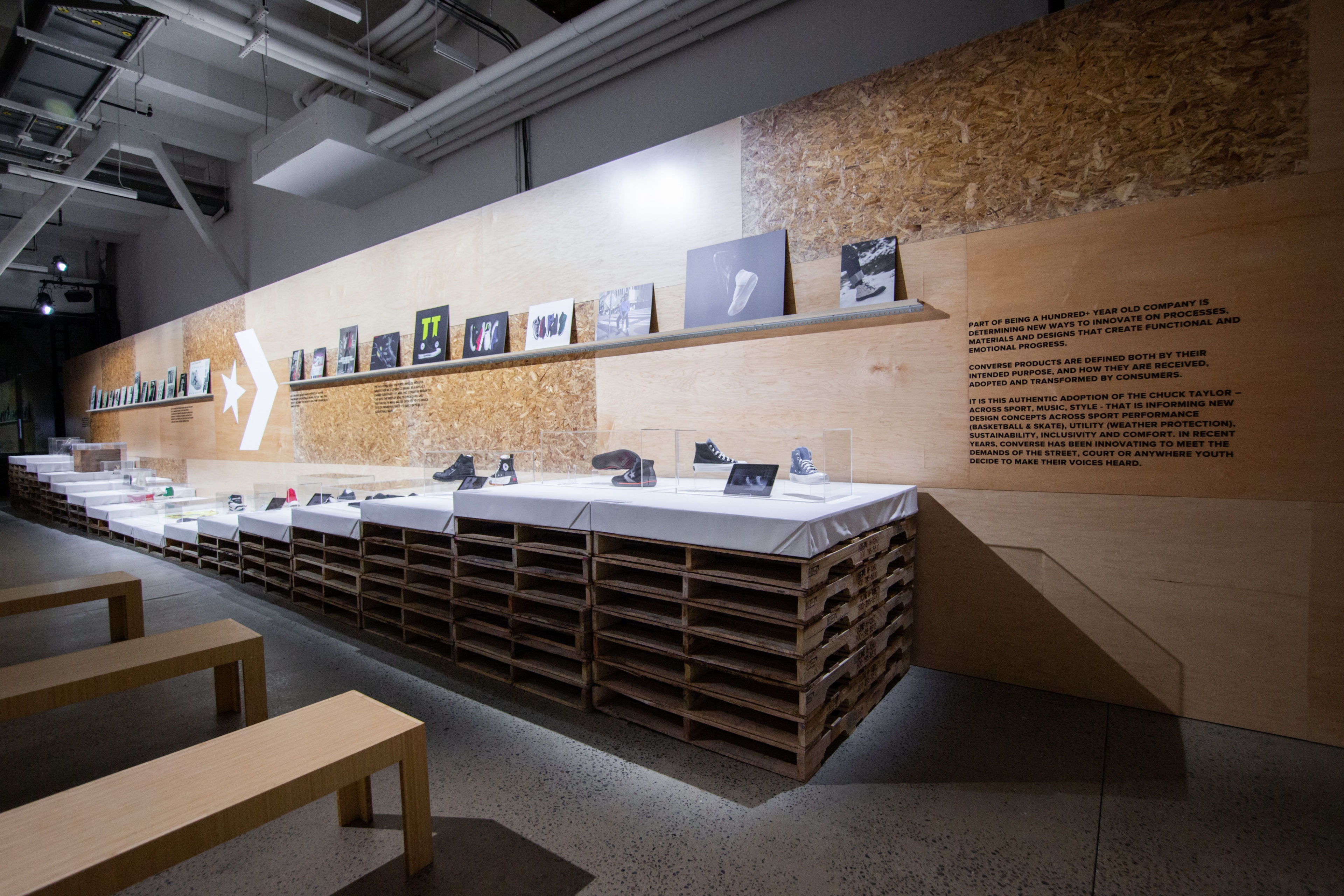 Wooden wall with books and shoes displayed