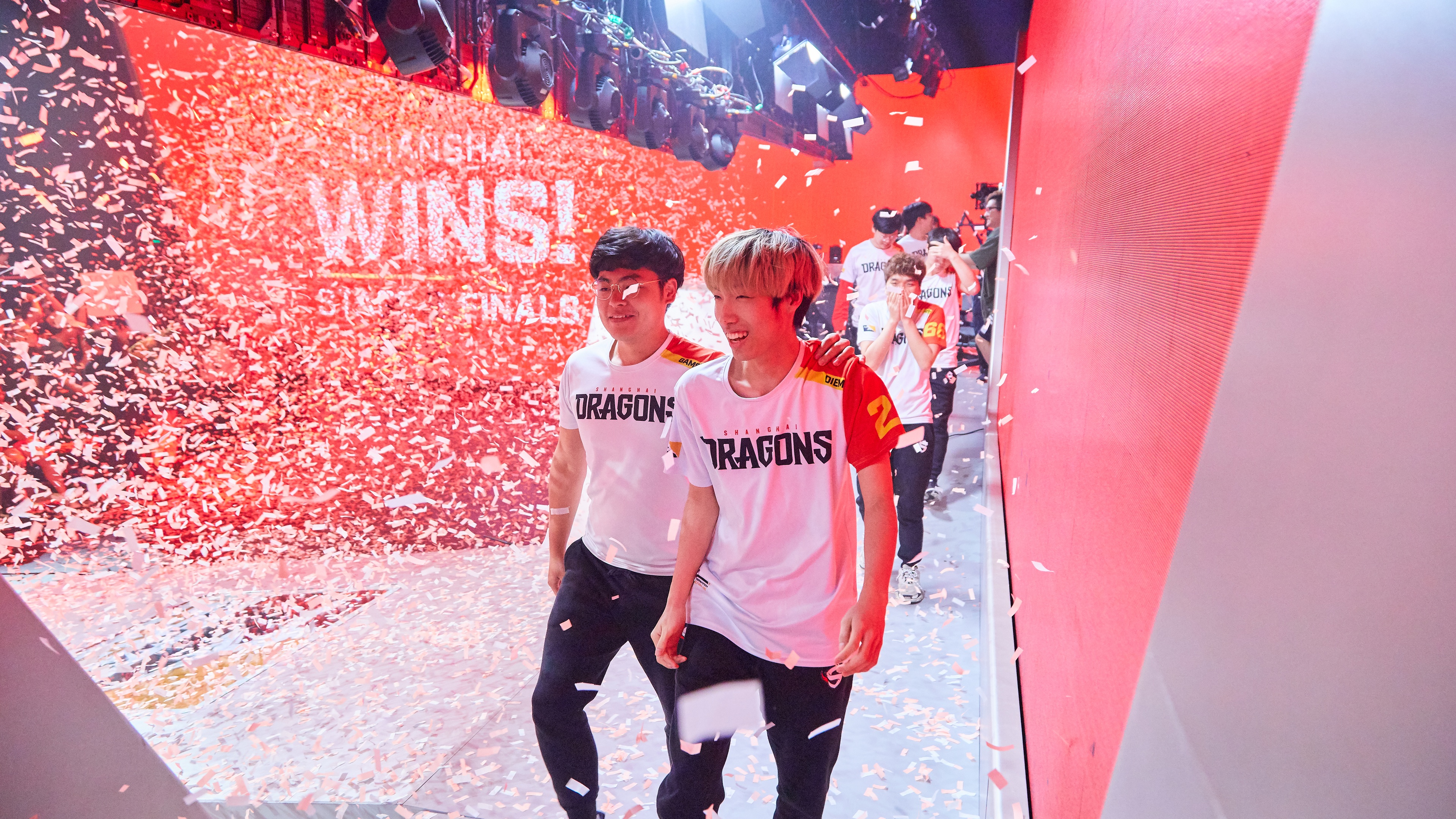 Shanghai Dragons smiling and posting with confetti