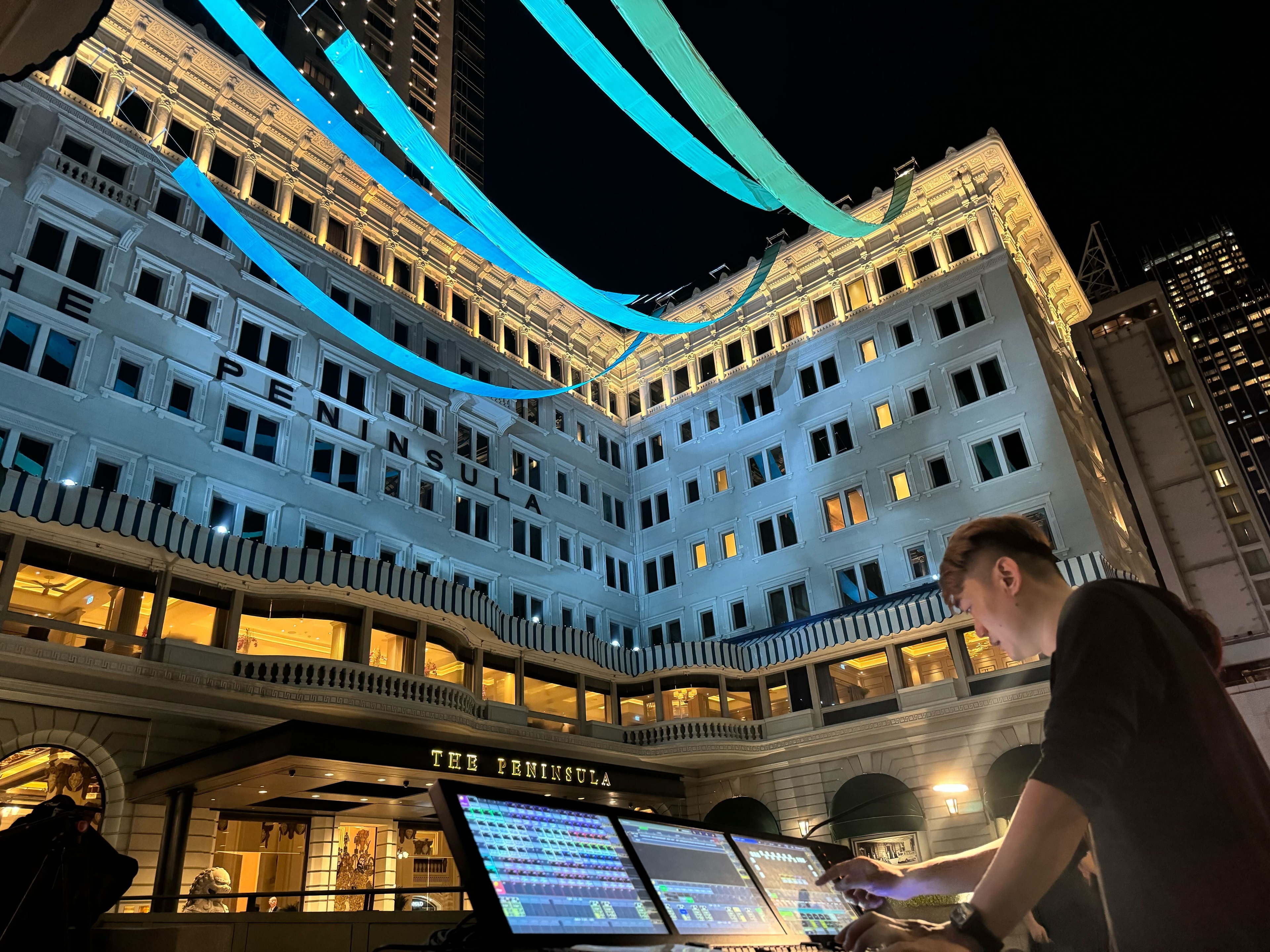 TAIT team members operating automation system outside of hotel