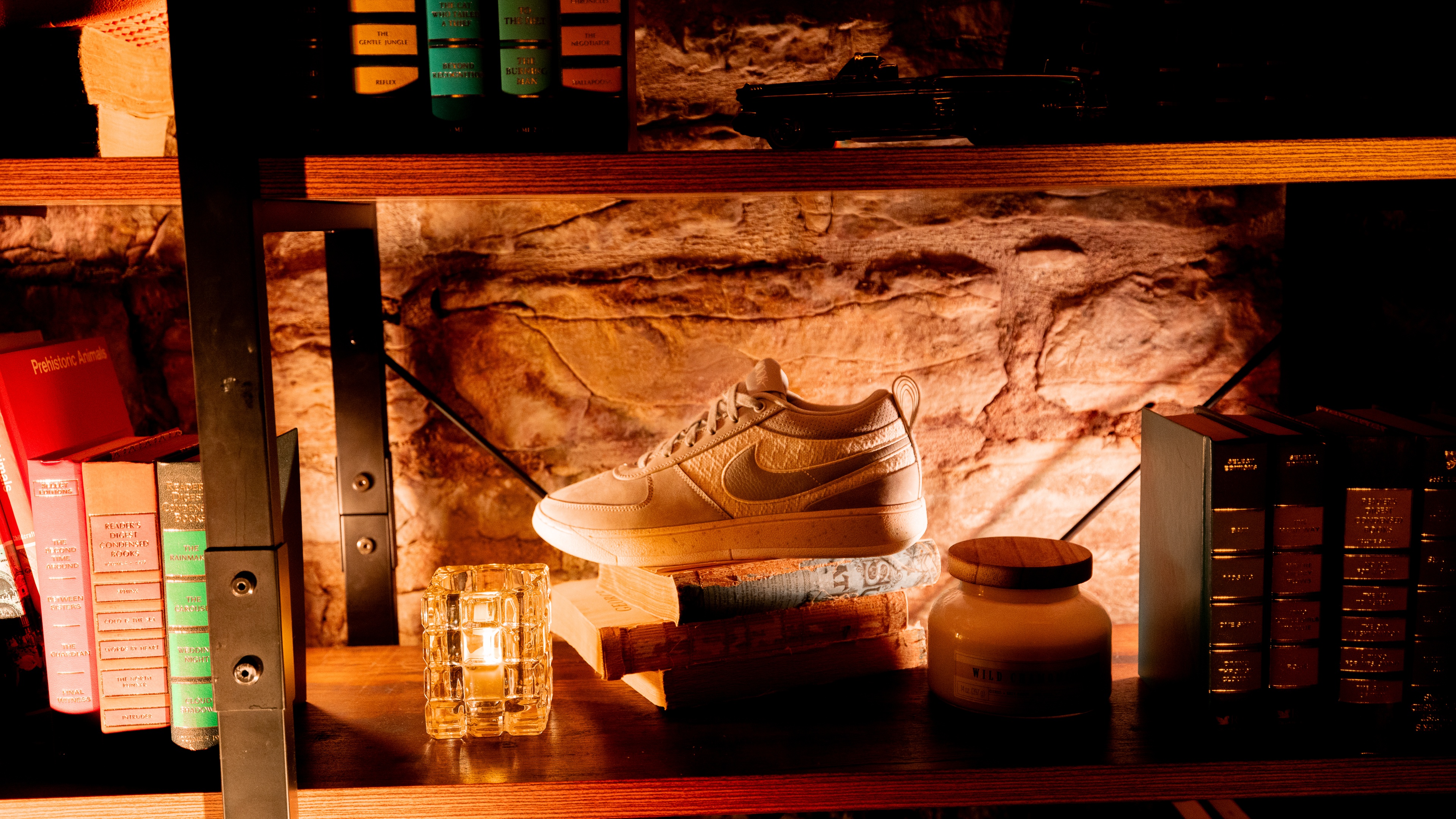 Dimly lit shelf with Nike shoe displayed with books