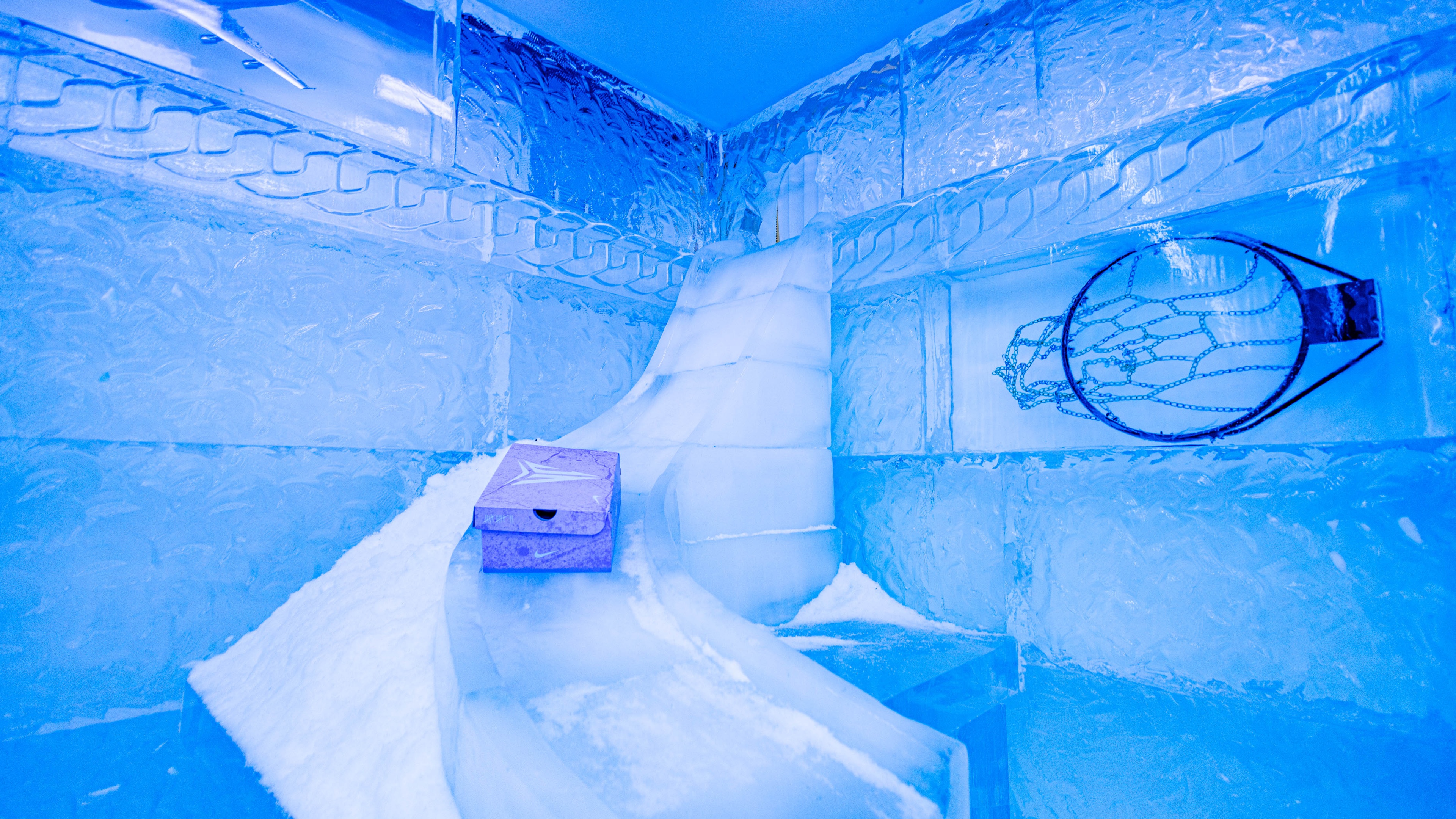 Ice themed Nike brand activation with slope made of ice and shoe box sliding down with basketball net prop