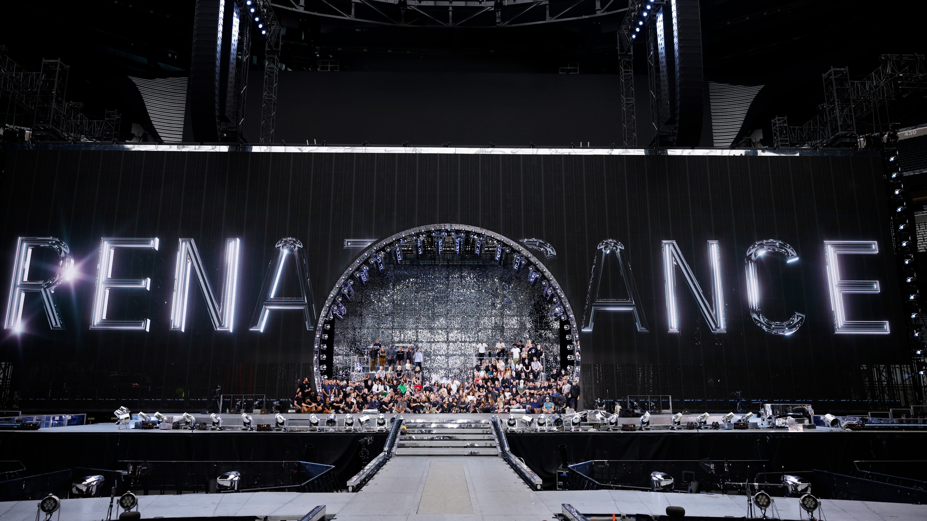 Beyonce Renaissance World Tour team posed in front of stage displaying Renaissance