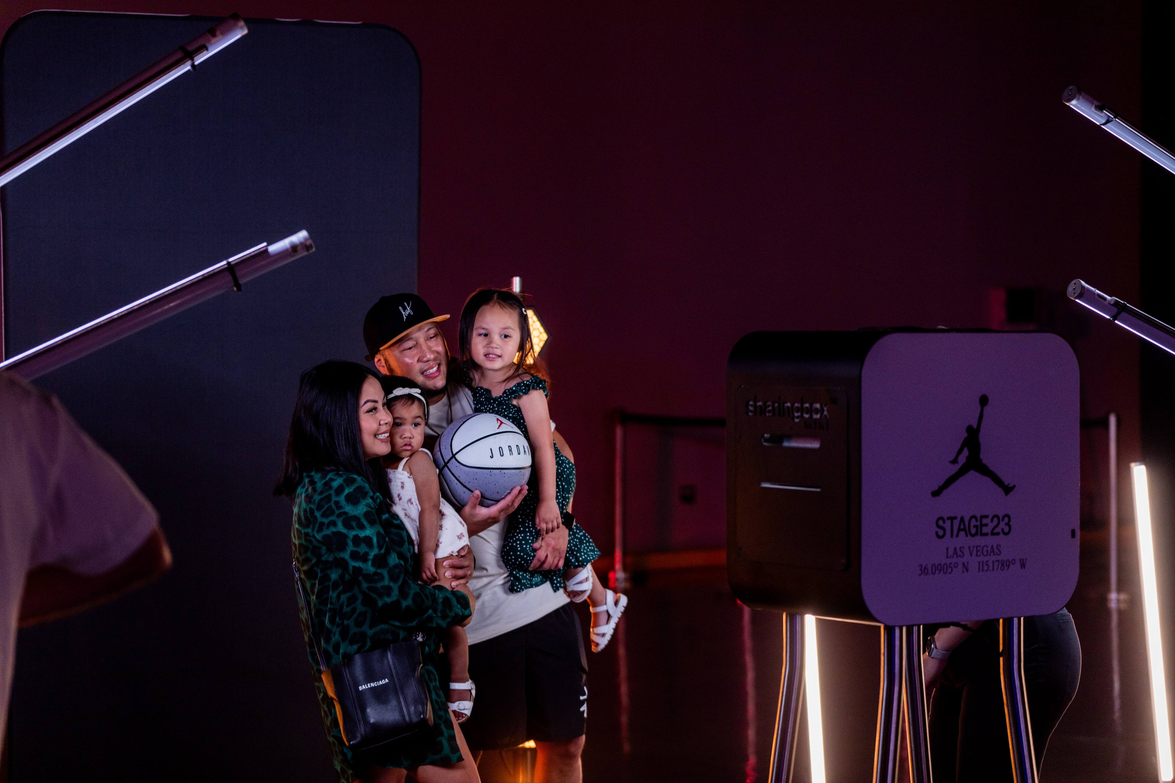 Nike Jordan Brand WNBA All-Star Weekend Las Vegas heterosexual couple holding their 2 daughters and a Jordan basket ball while posing in front of a sharingbox photo box stand