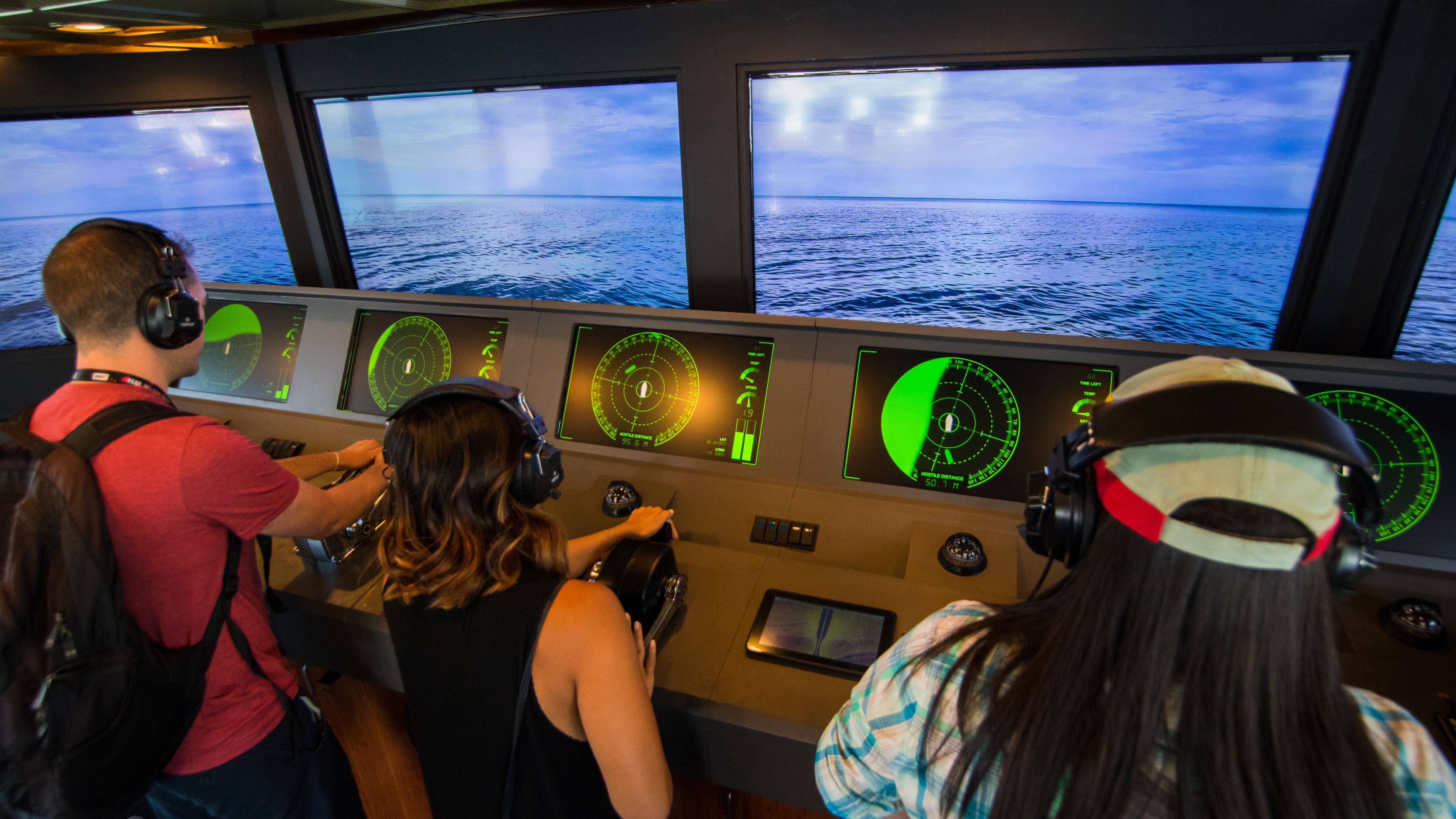 Three people simulating sailing a ship