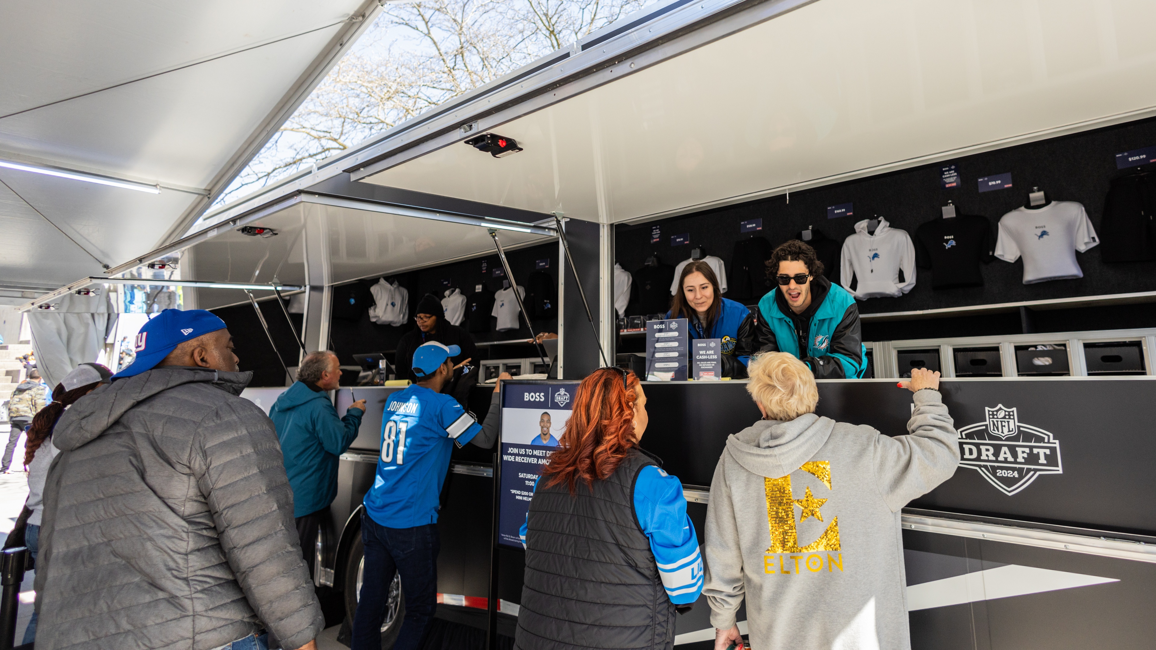 Event attendees ordering at merch tent