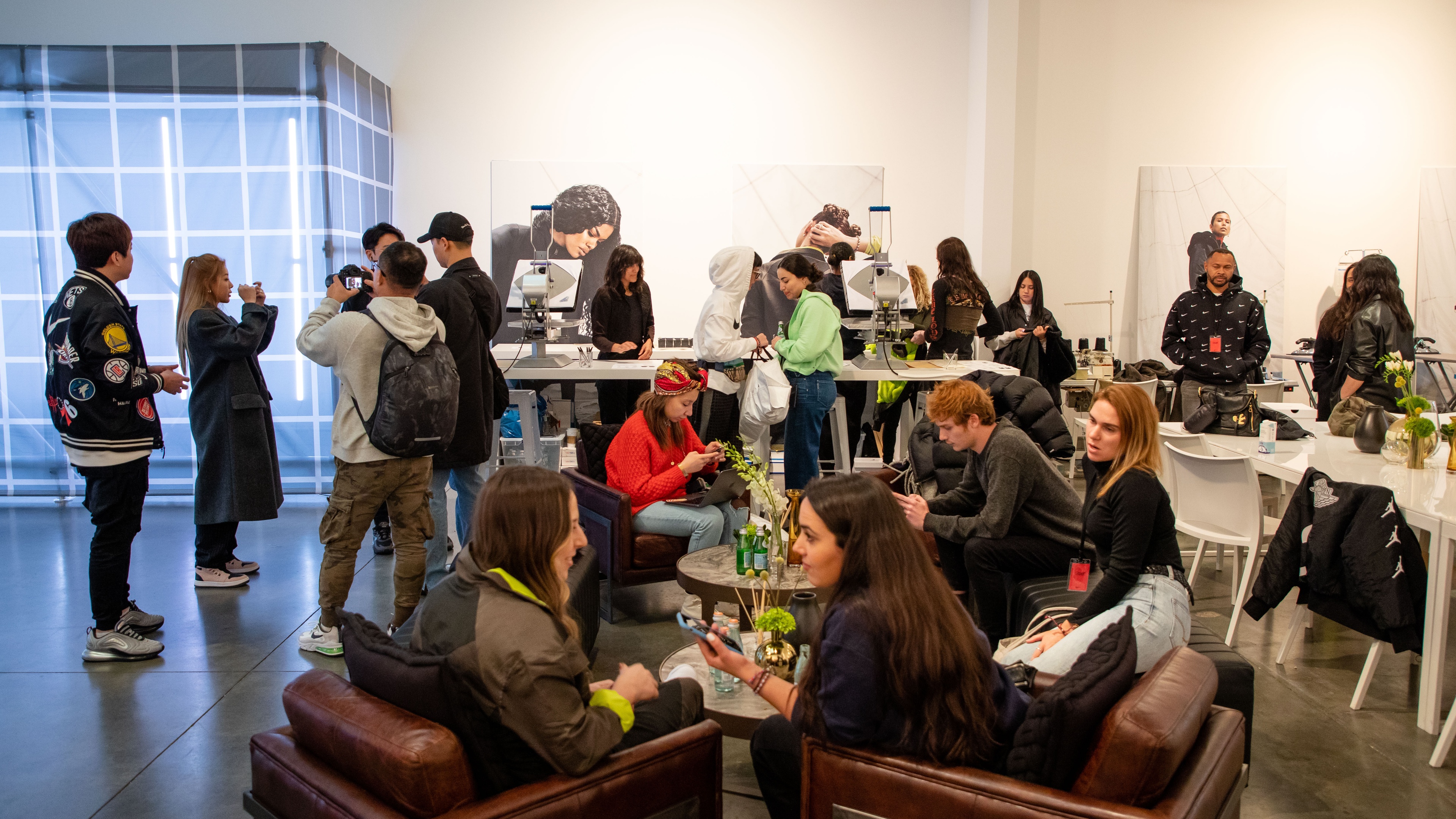Guests sitting and talking with apparel printing in background