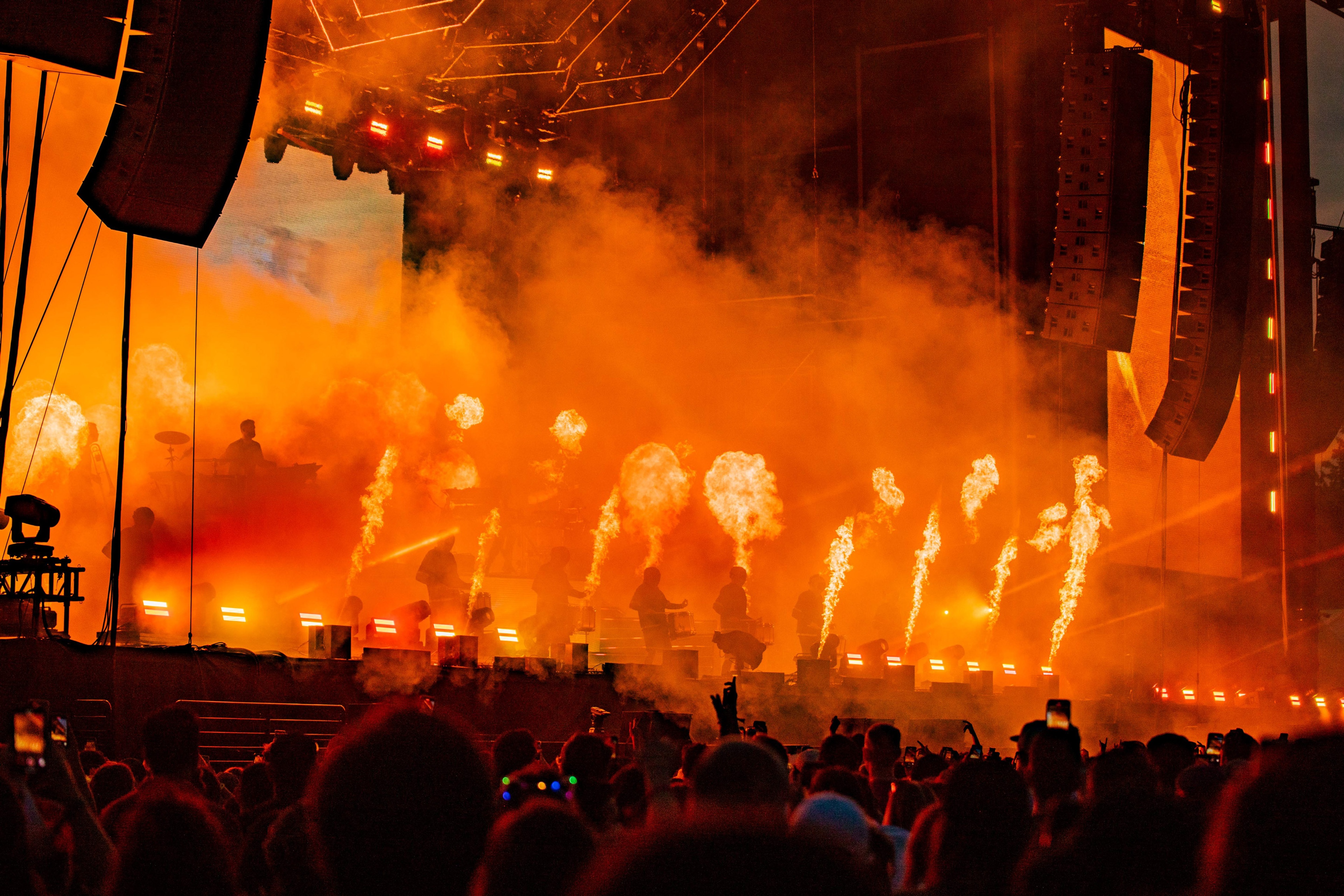 Founders Entertainment The Governors Ball crowd facing drum performers on a stage lit up orange with fire shooting out