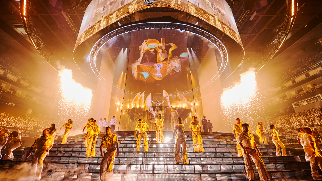 performers on a staircase stage set up with yellow lights and sparklers