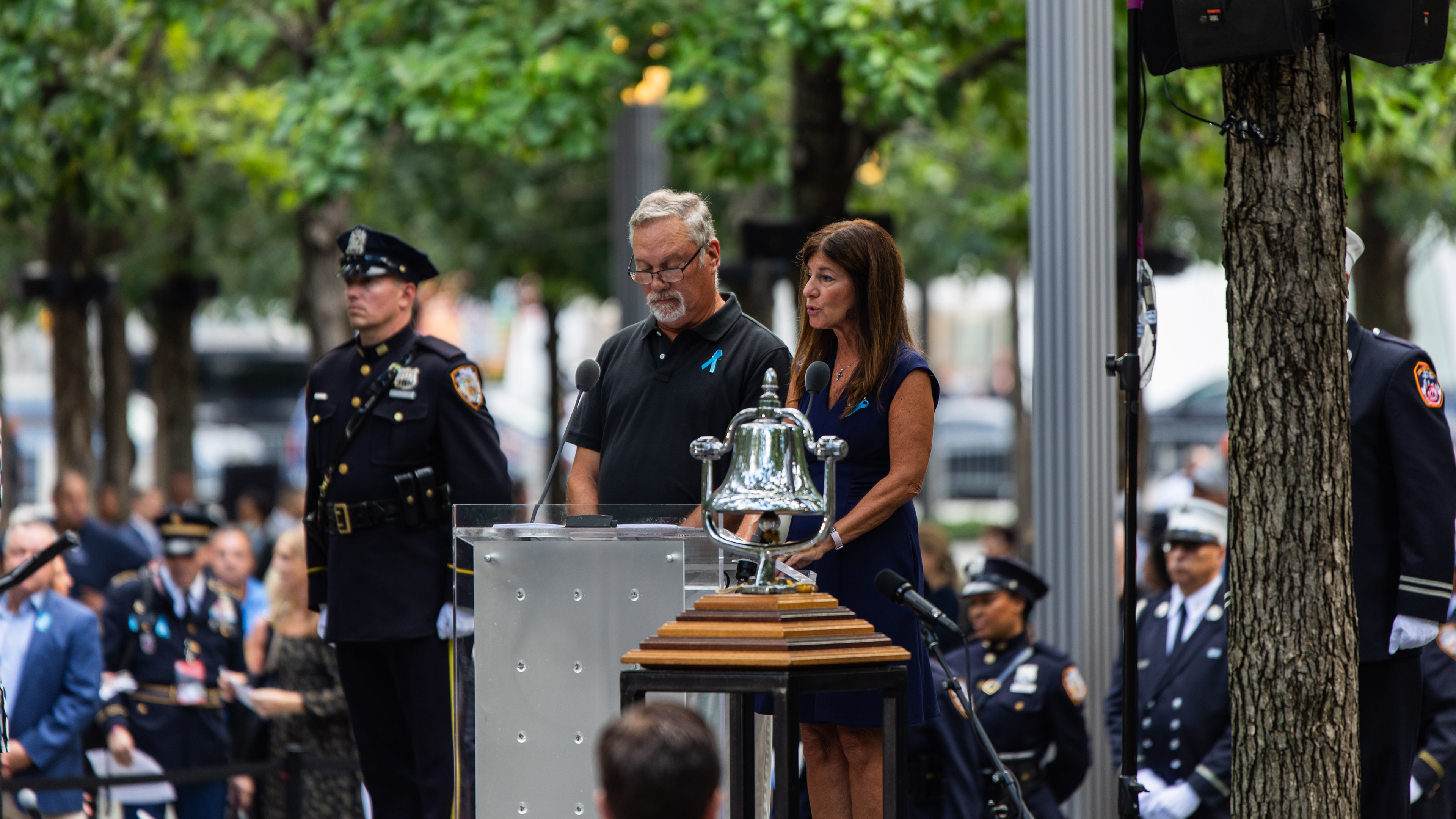 2 speakers at the 9/11 commemoration stood at podium with military figures