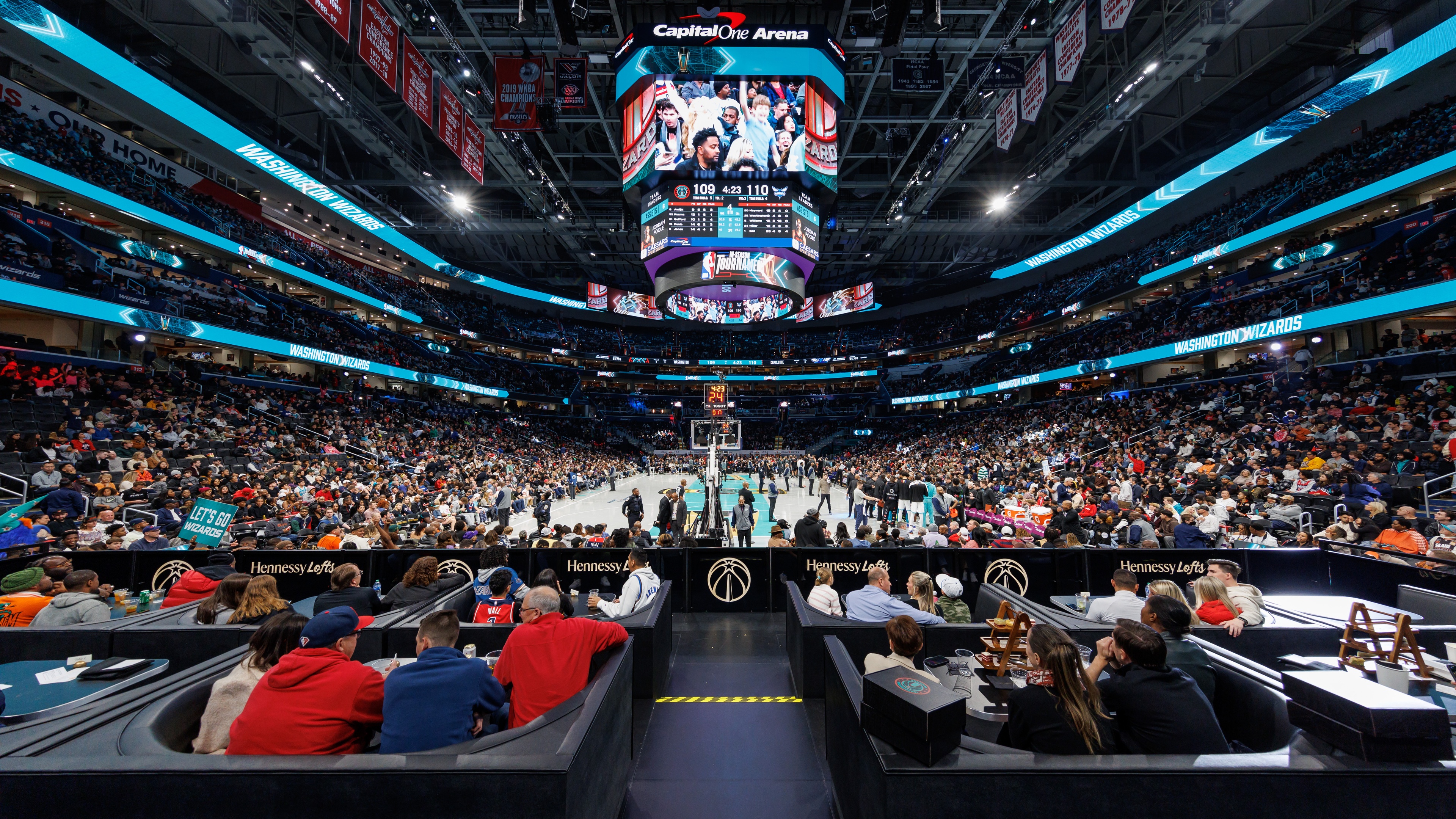 wide angle shot of the Monumental Sports & Entertainment stadium from the Washington Wizards VIP Hennessy Lofts, crowd watching a basketball game