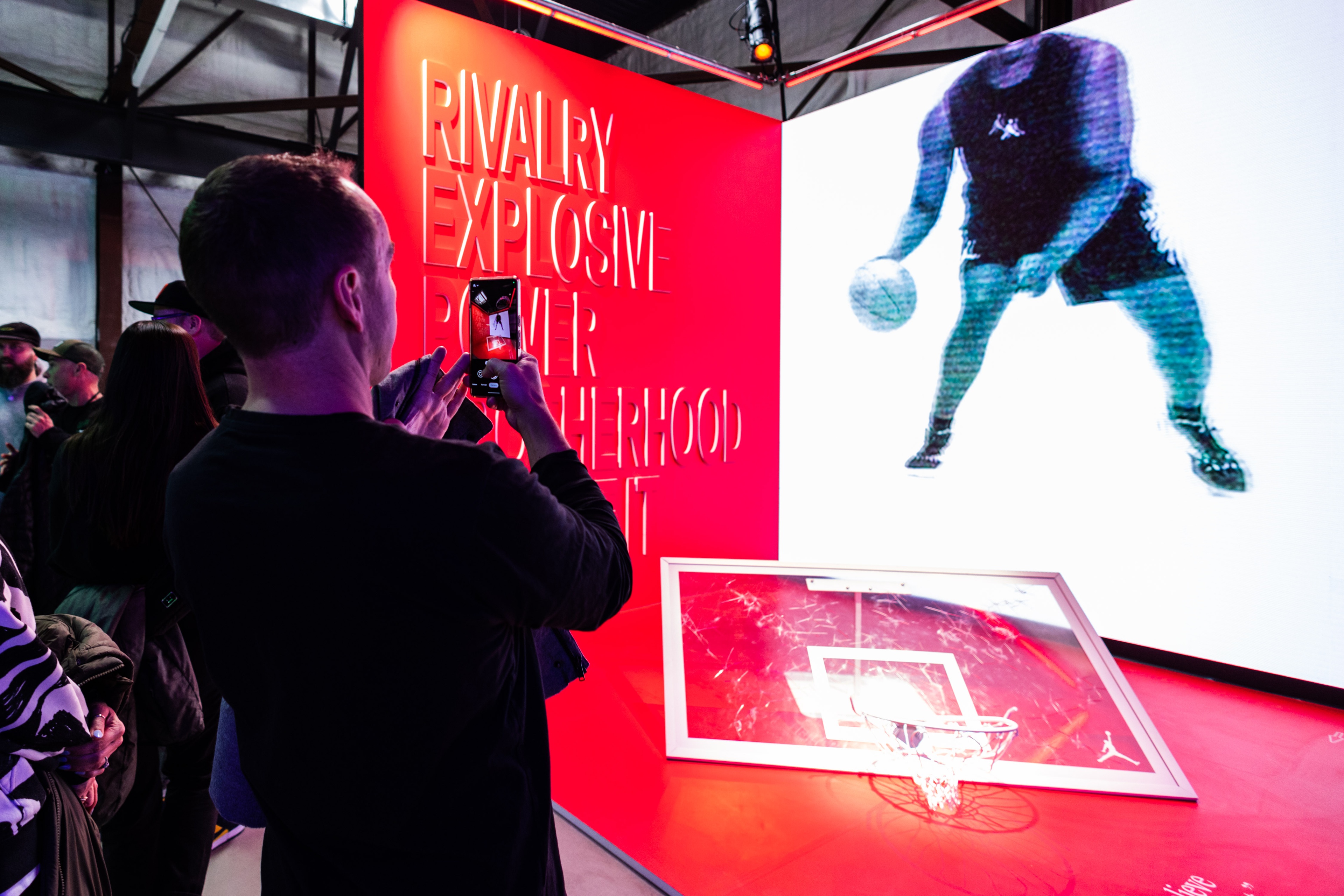 Jordan Parlor23 guest taking an image of red installation