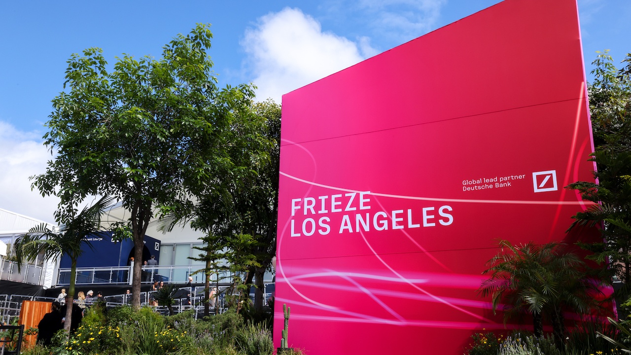 Pink Frieze Los Angeles sign surrounded by trees