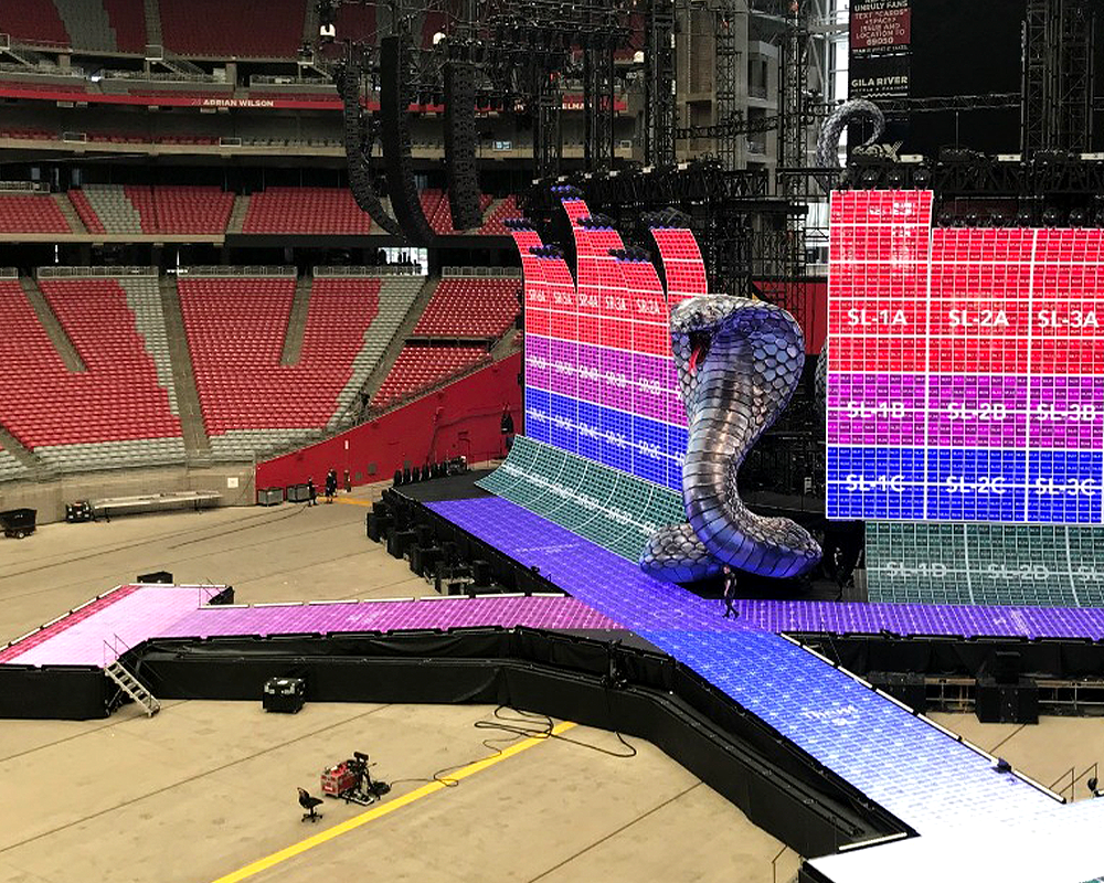 in-progress stage building featured a large snake sculpture and screens