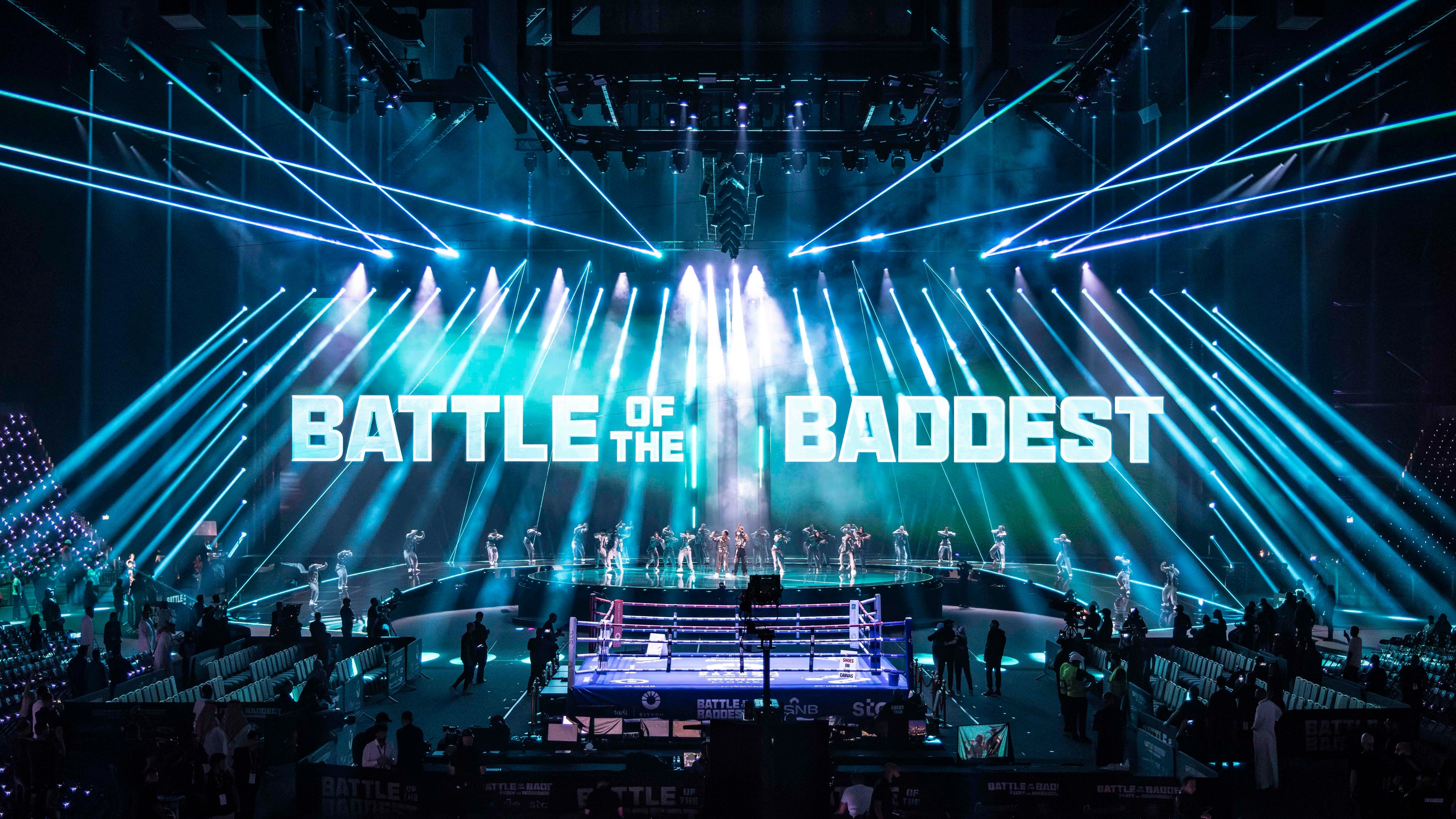 Lit up blue stage with Battle of the Baddest behind it