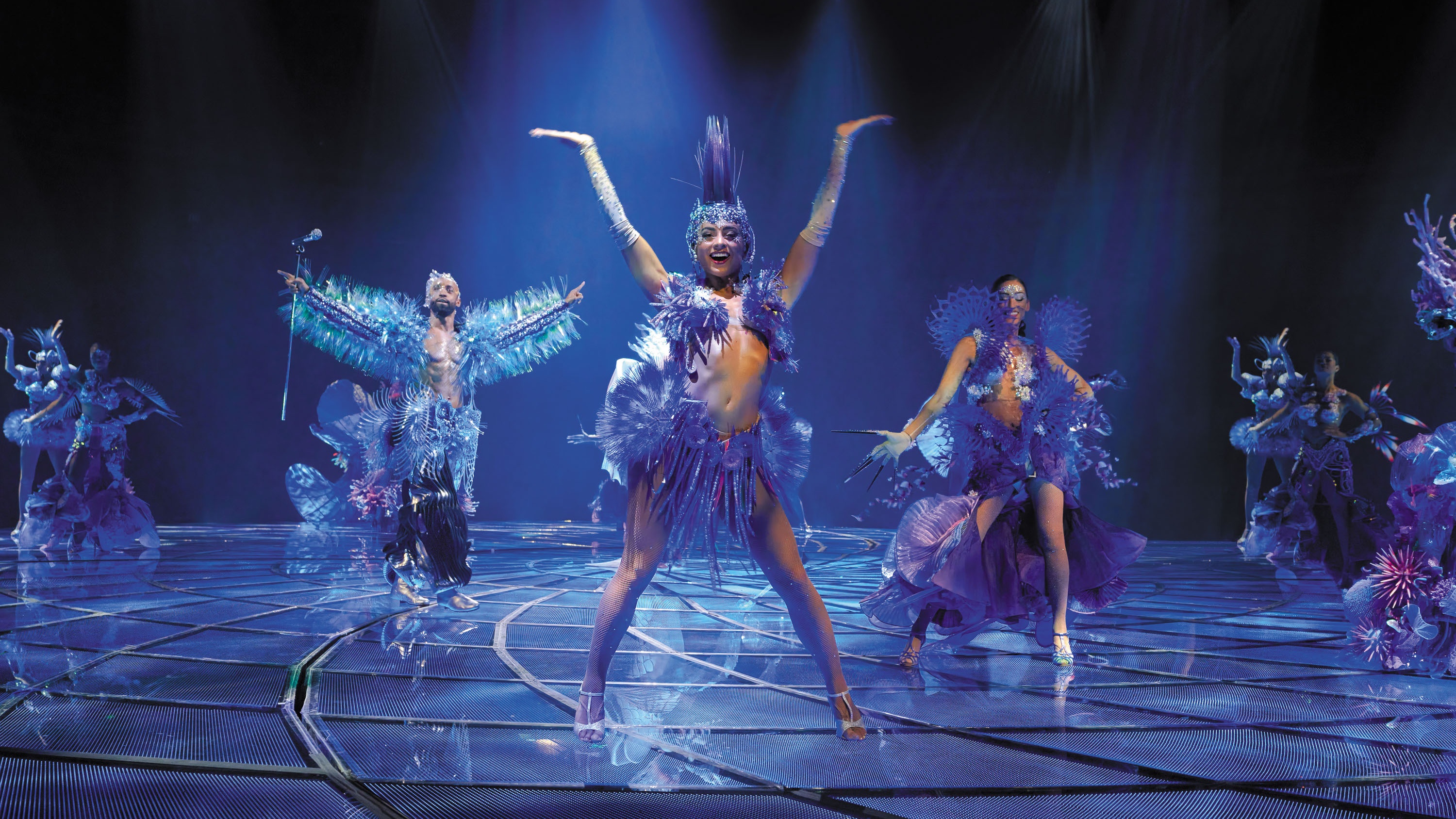 Awakening performers on stage in costume in blue lighting