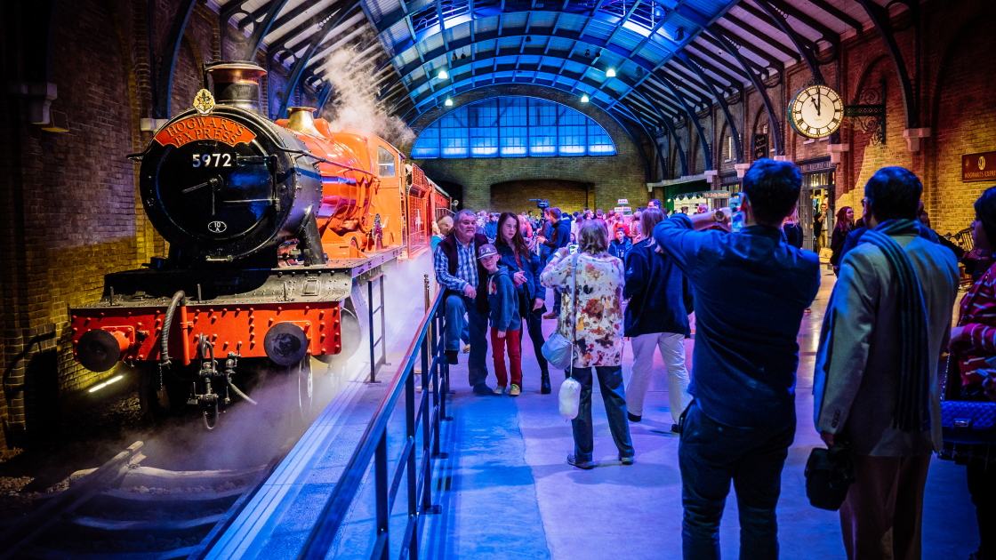 image of family and crowd posing in front of harry potter train