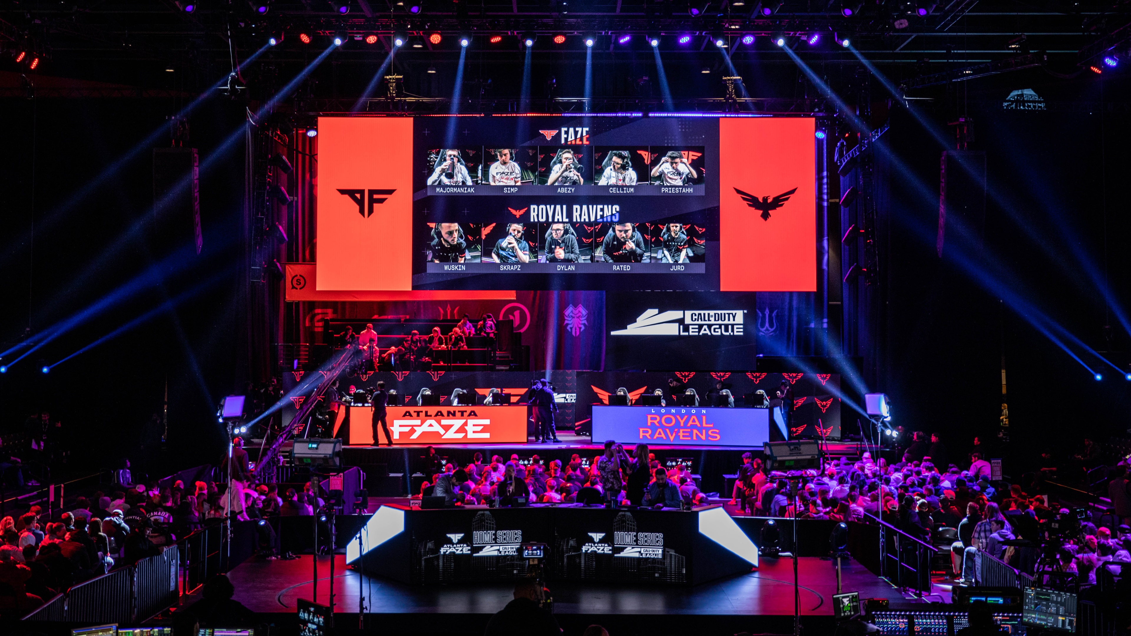 Atlanta FaZe and Royal Ravens on stage competing with purple and red lights