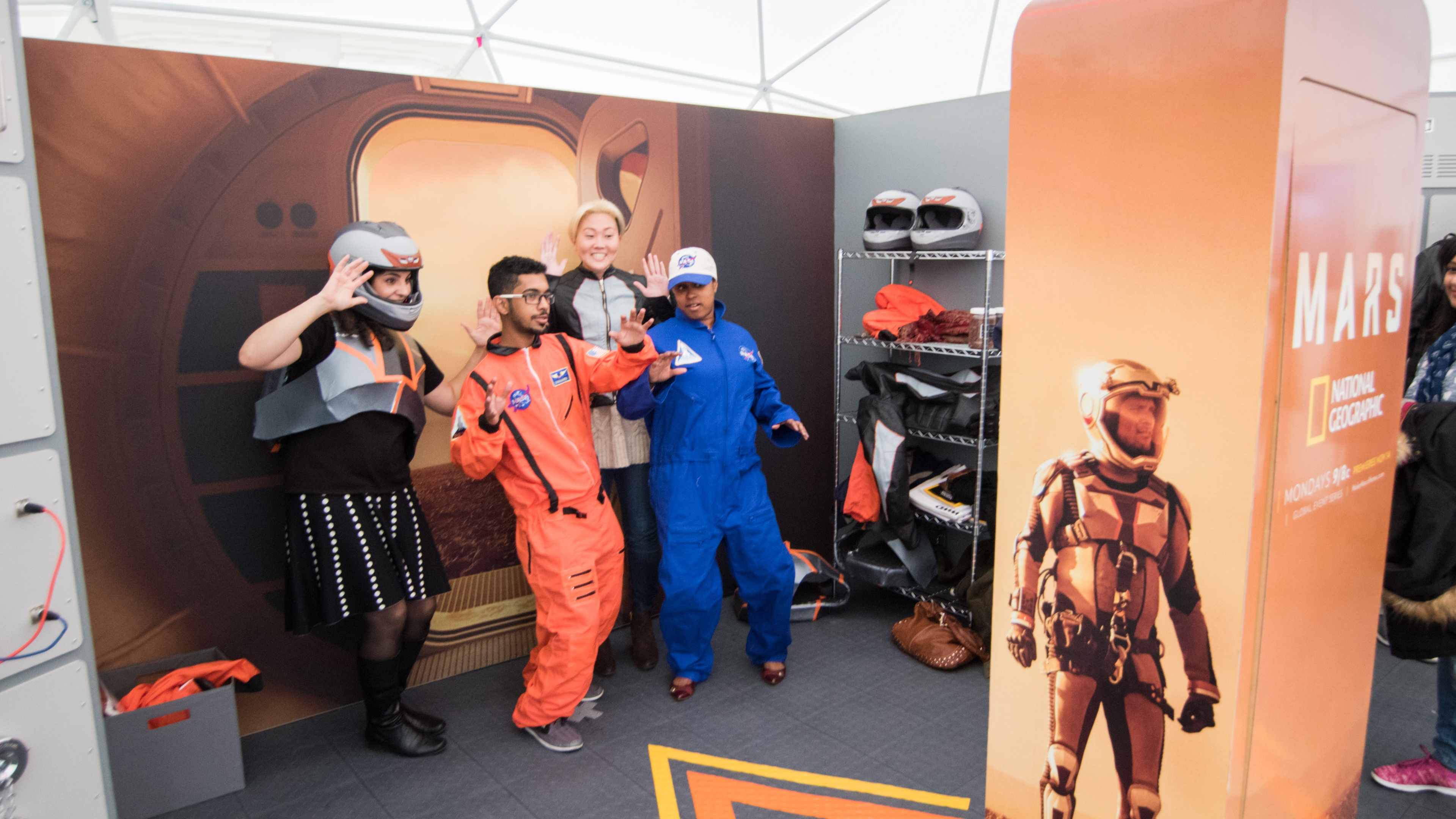 Experience MARS guests in space suits posing for photo