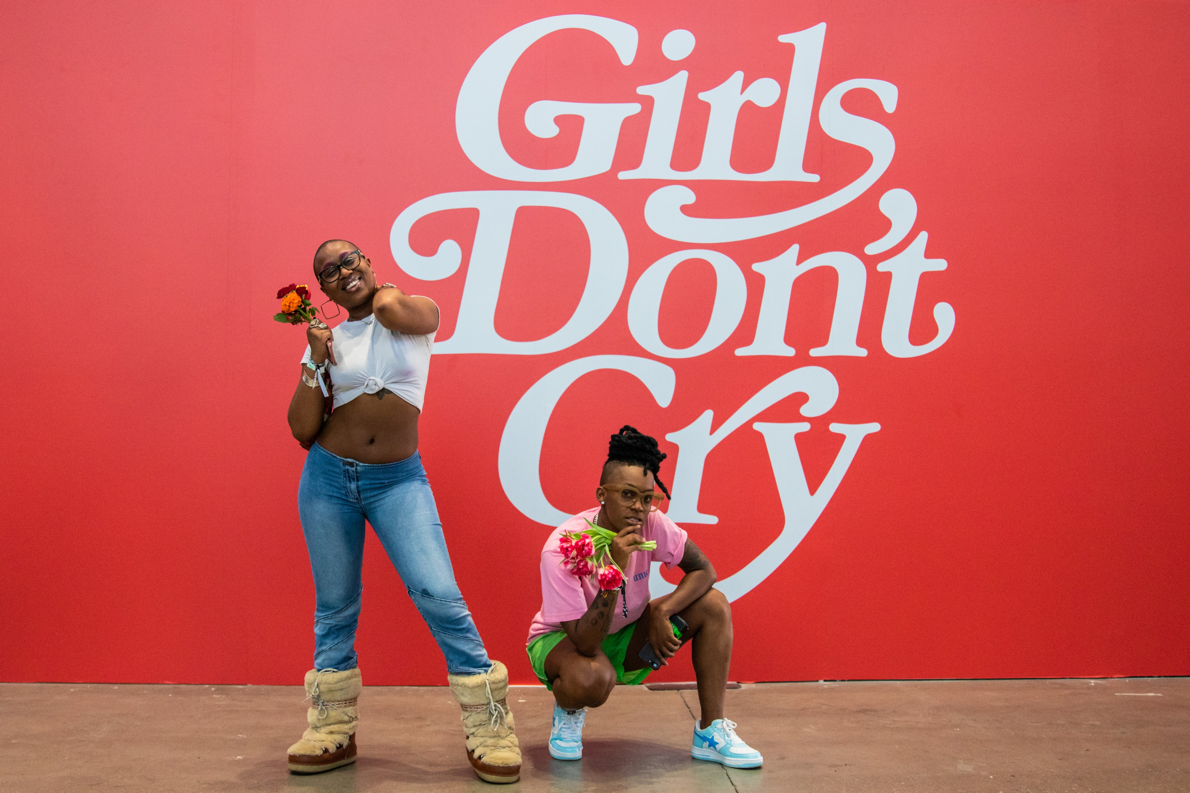 Two women in front of Girls Don't Cry mural