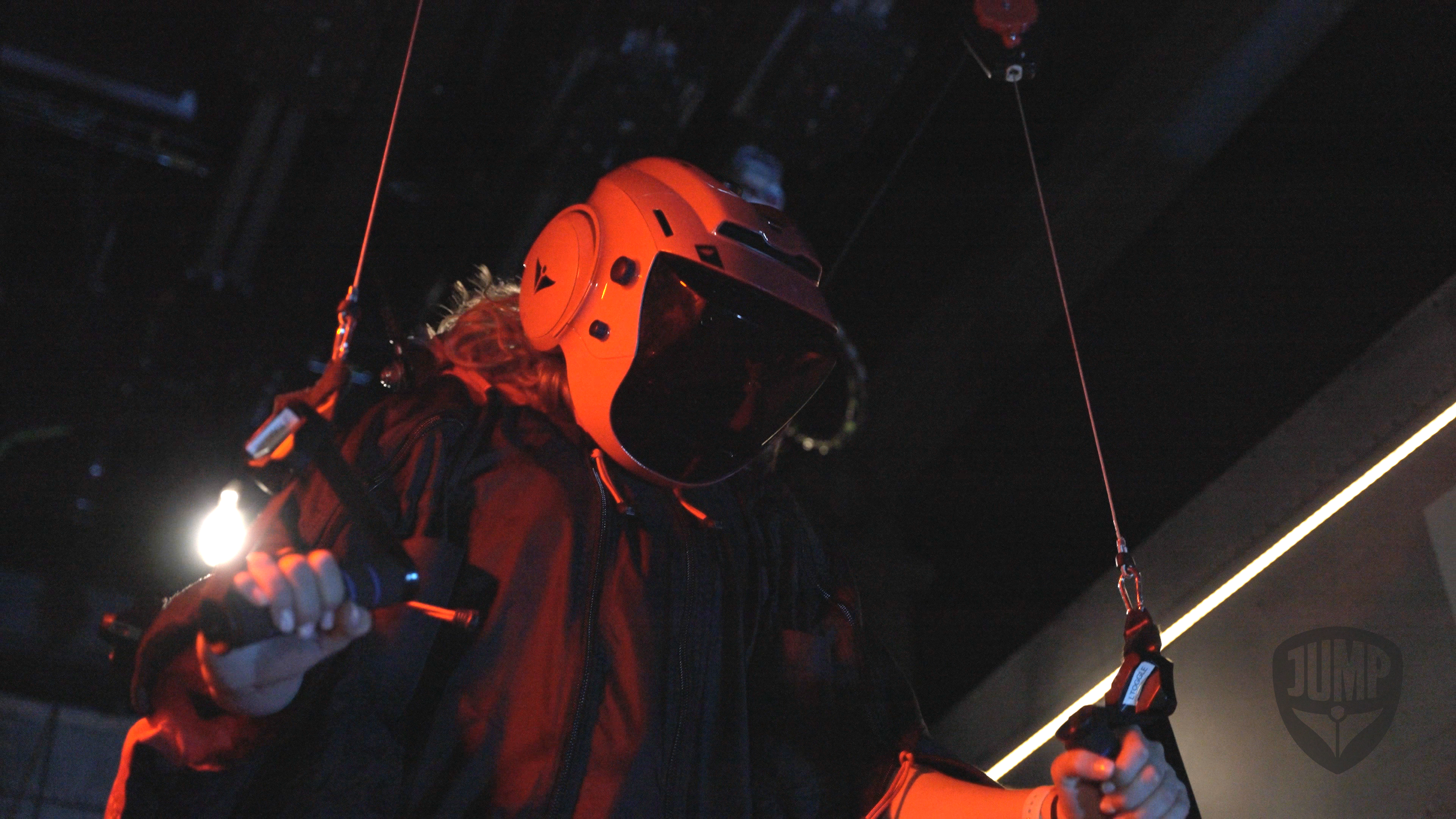 Woman wearing wing suit in virtual simulator