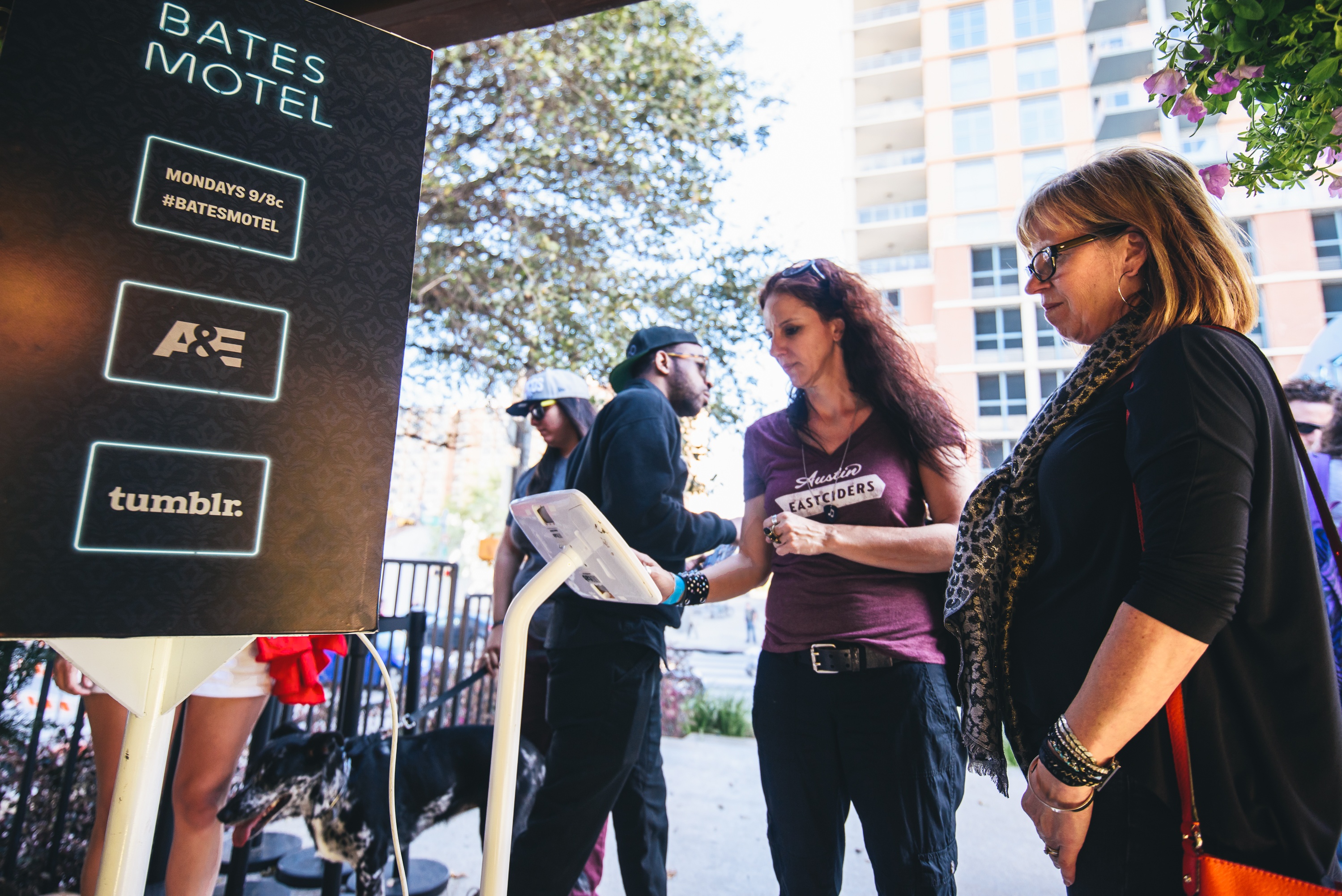 2 females checking in on the screen at the entrance of the Bates Motel experience at SXSW