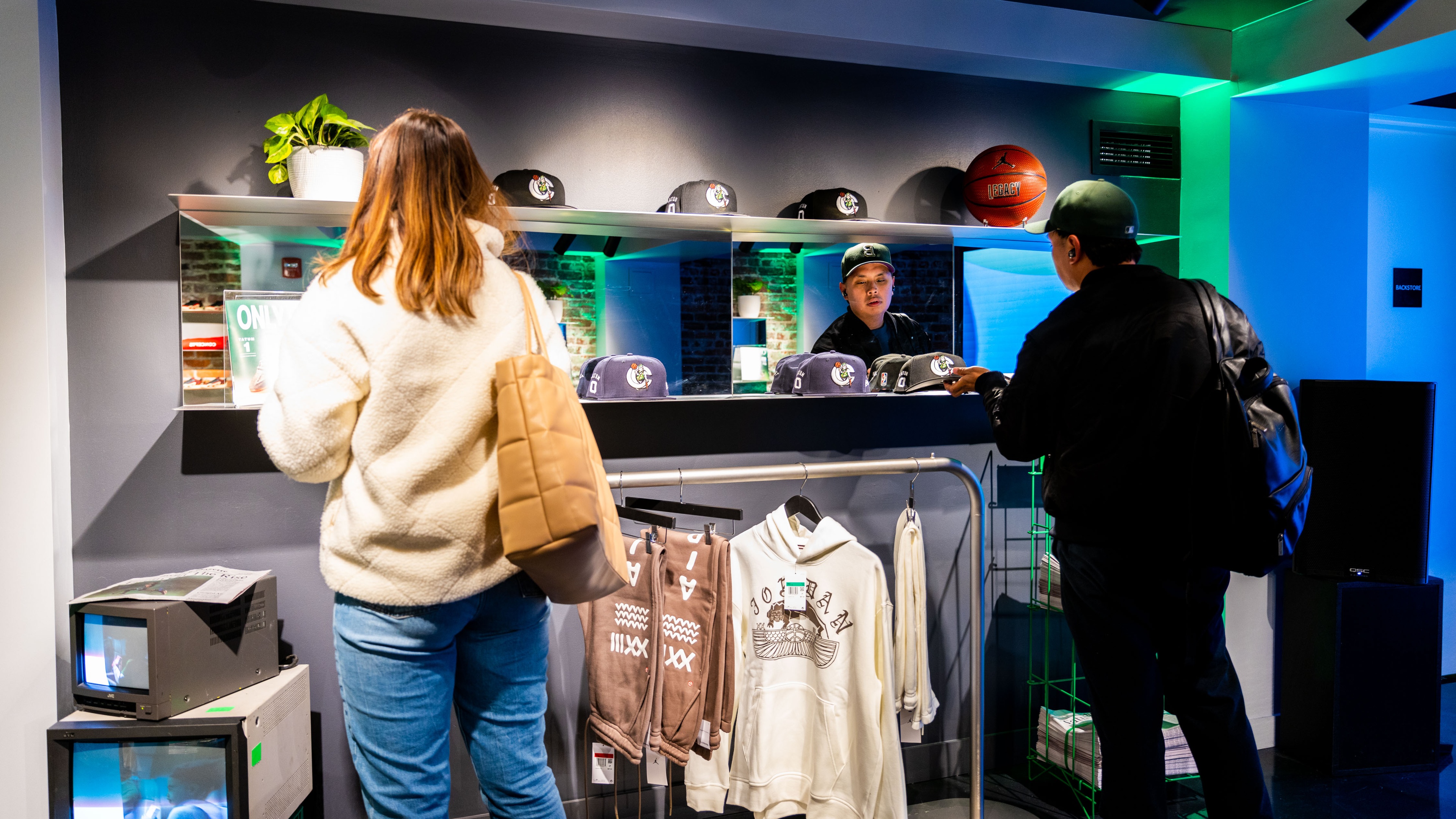 people stood at counter paying for Nike merchandise