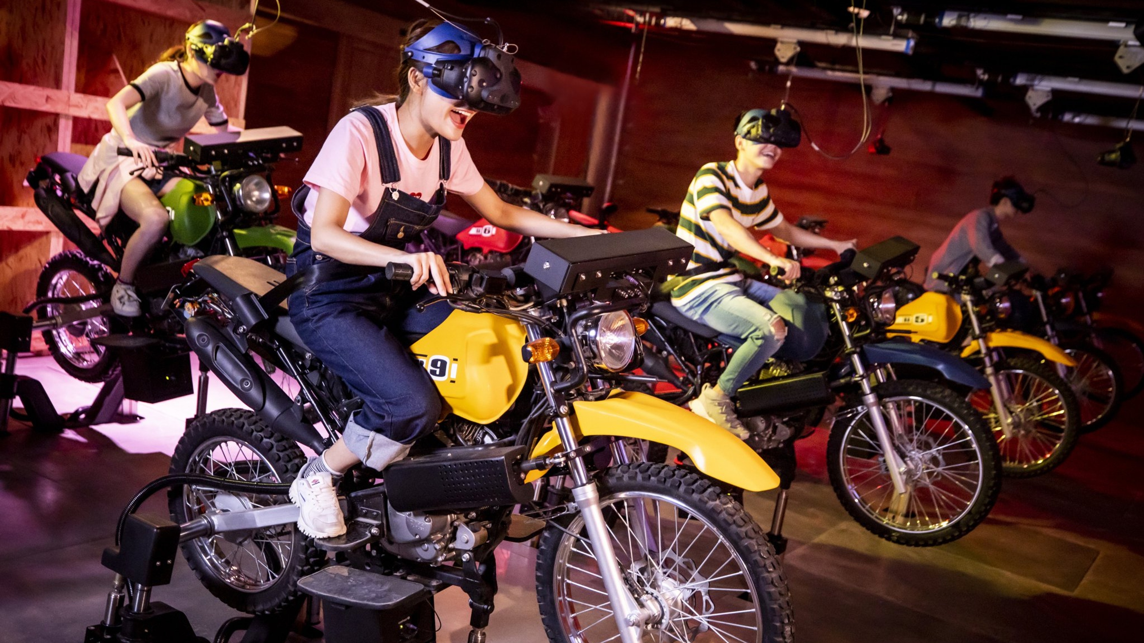 Children riding motorcycles in an immersive VR environment wearing headsets