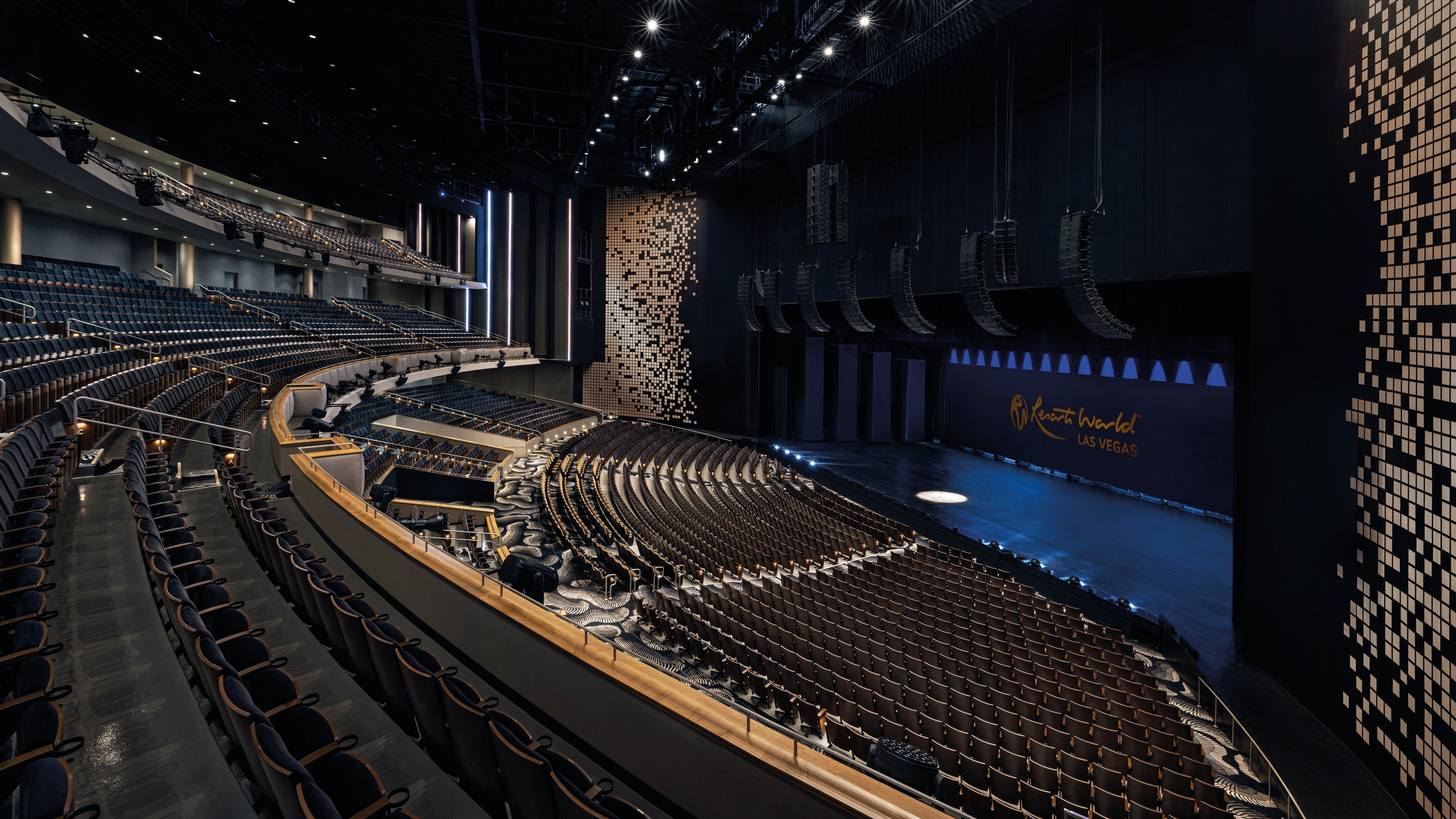 Large theatre with 3 tiers of seating gold decorations spot lights and sound system