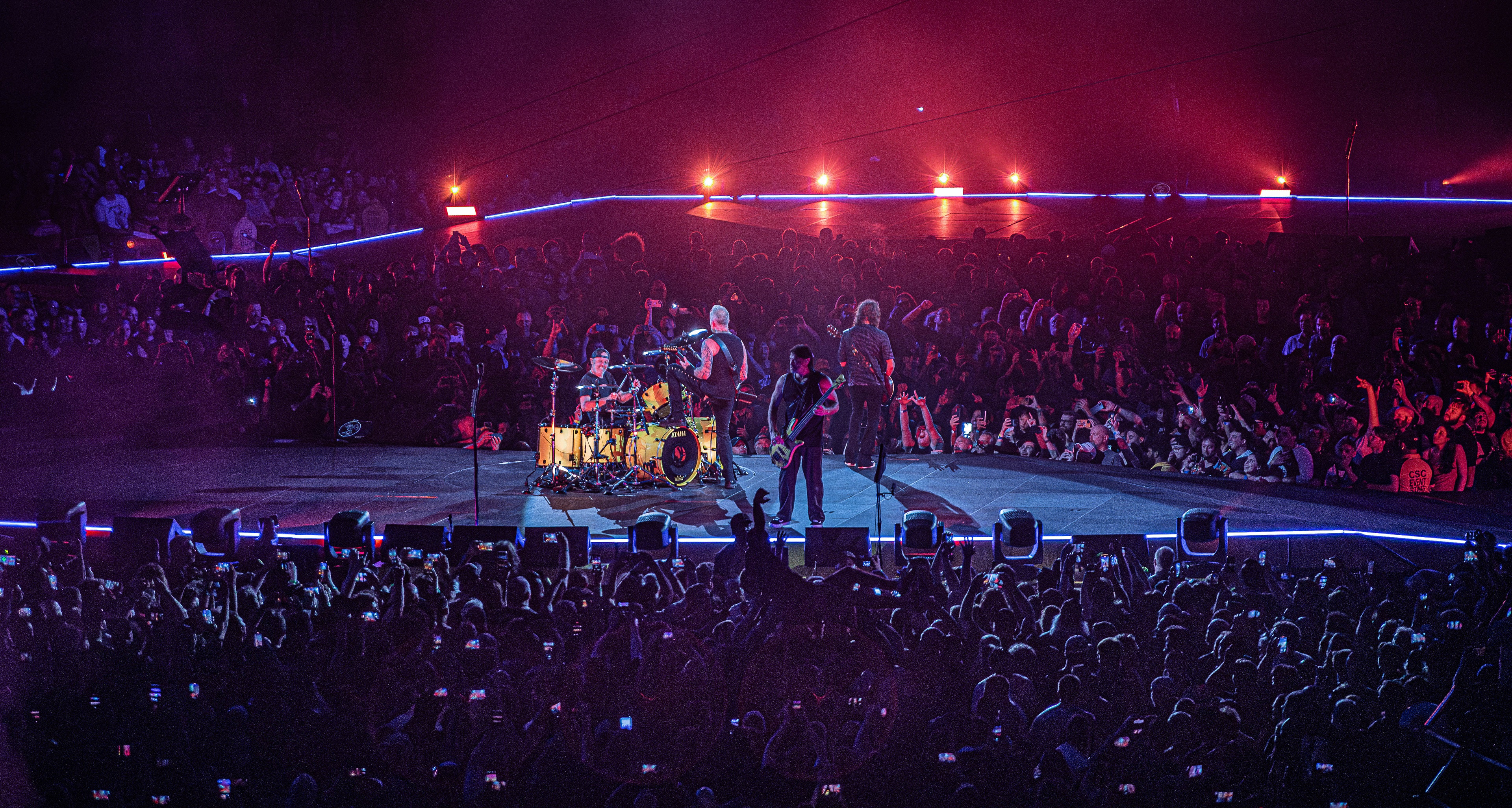 Metallica M72 stage in lit up red surrounded by crowd