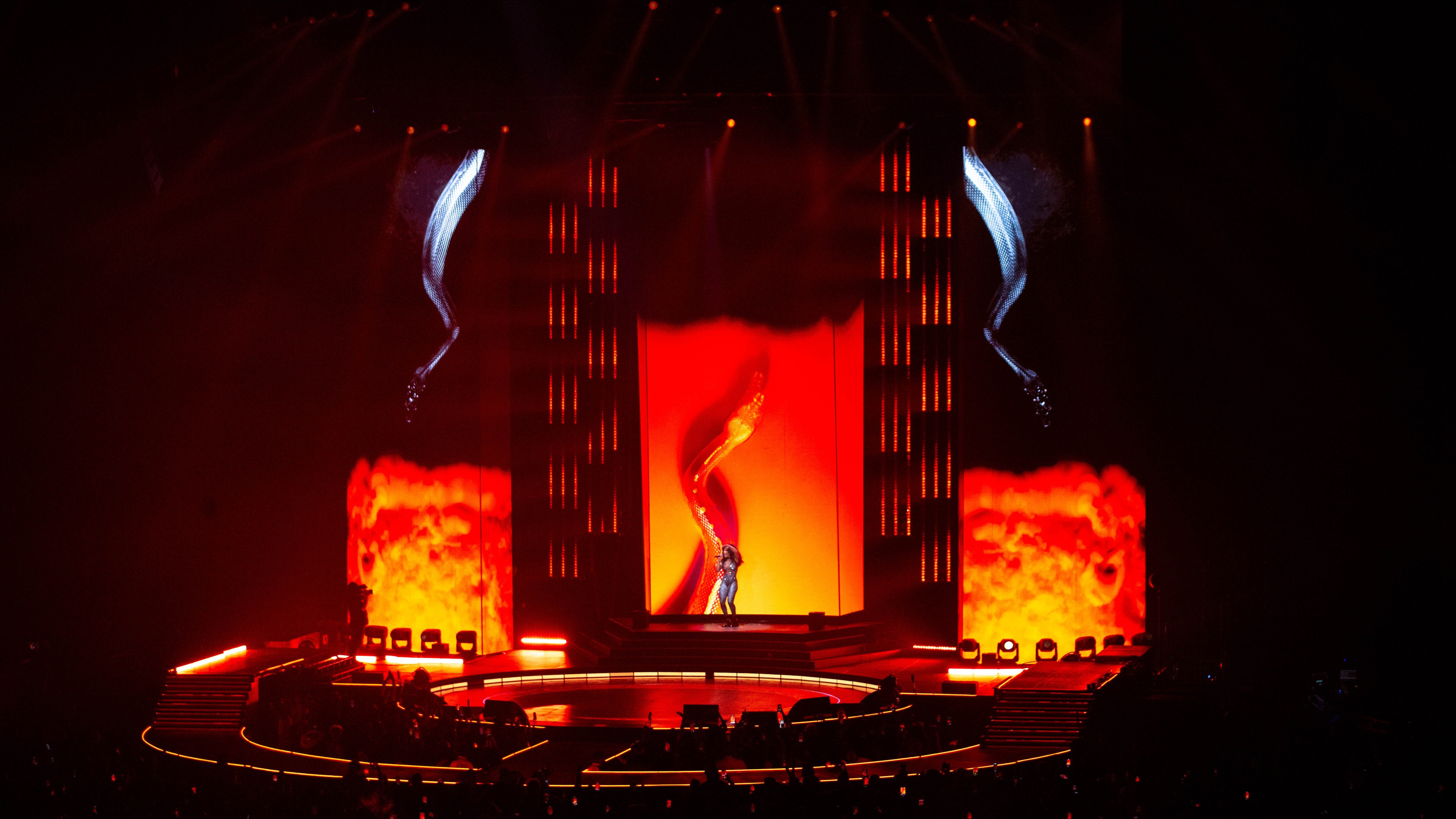Wide shot of stage with red and yellow LED screens