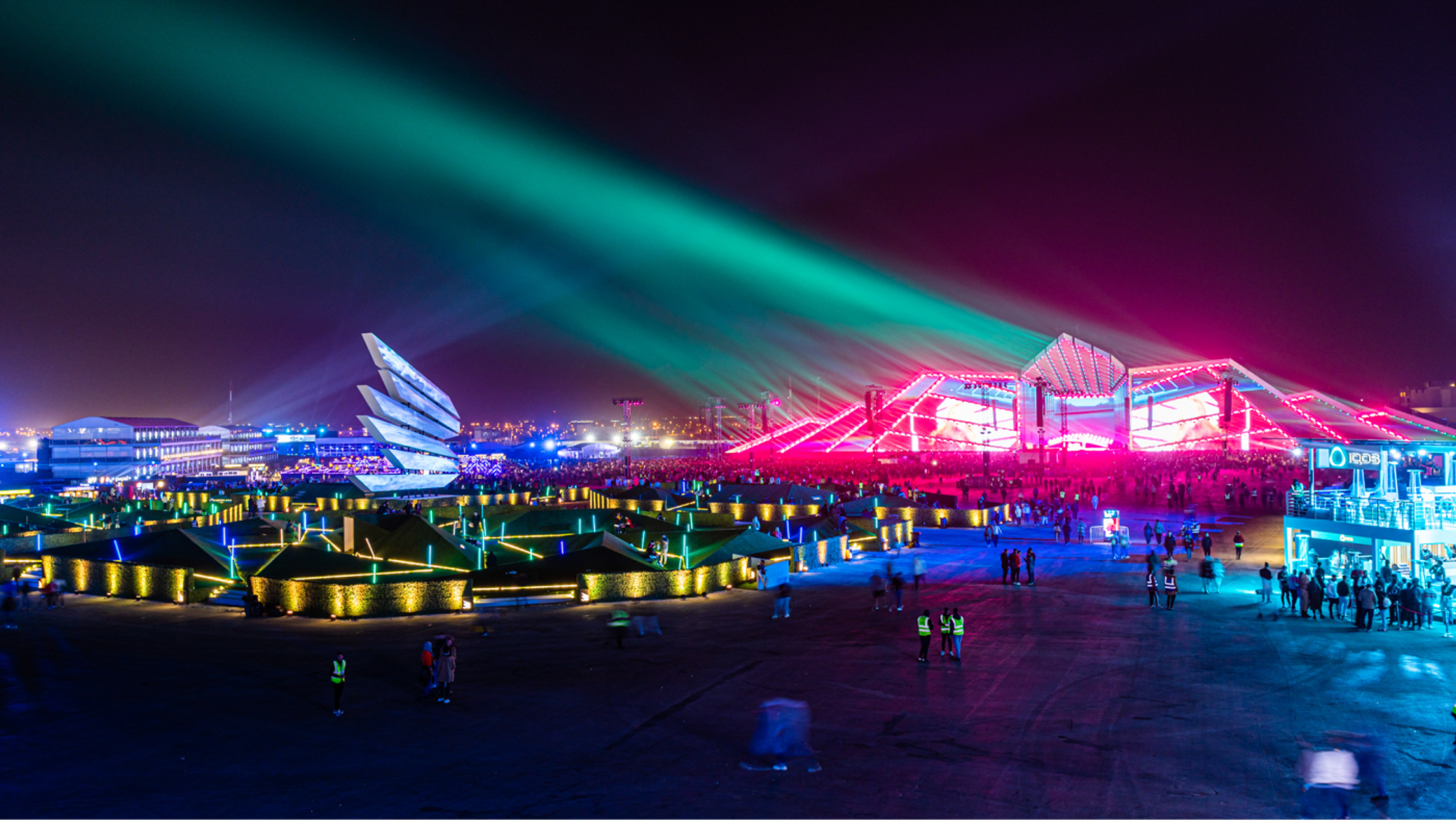 landscape image of soundstorm festival at night with a variety of colorful lights