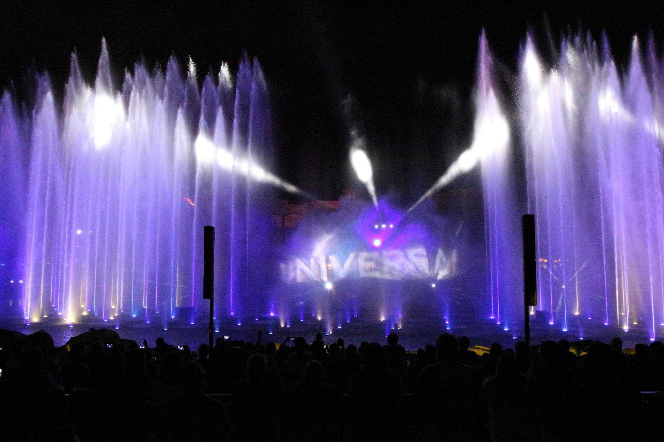 Light show at night with Universal globe in background