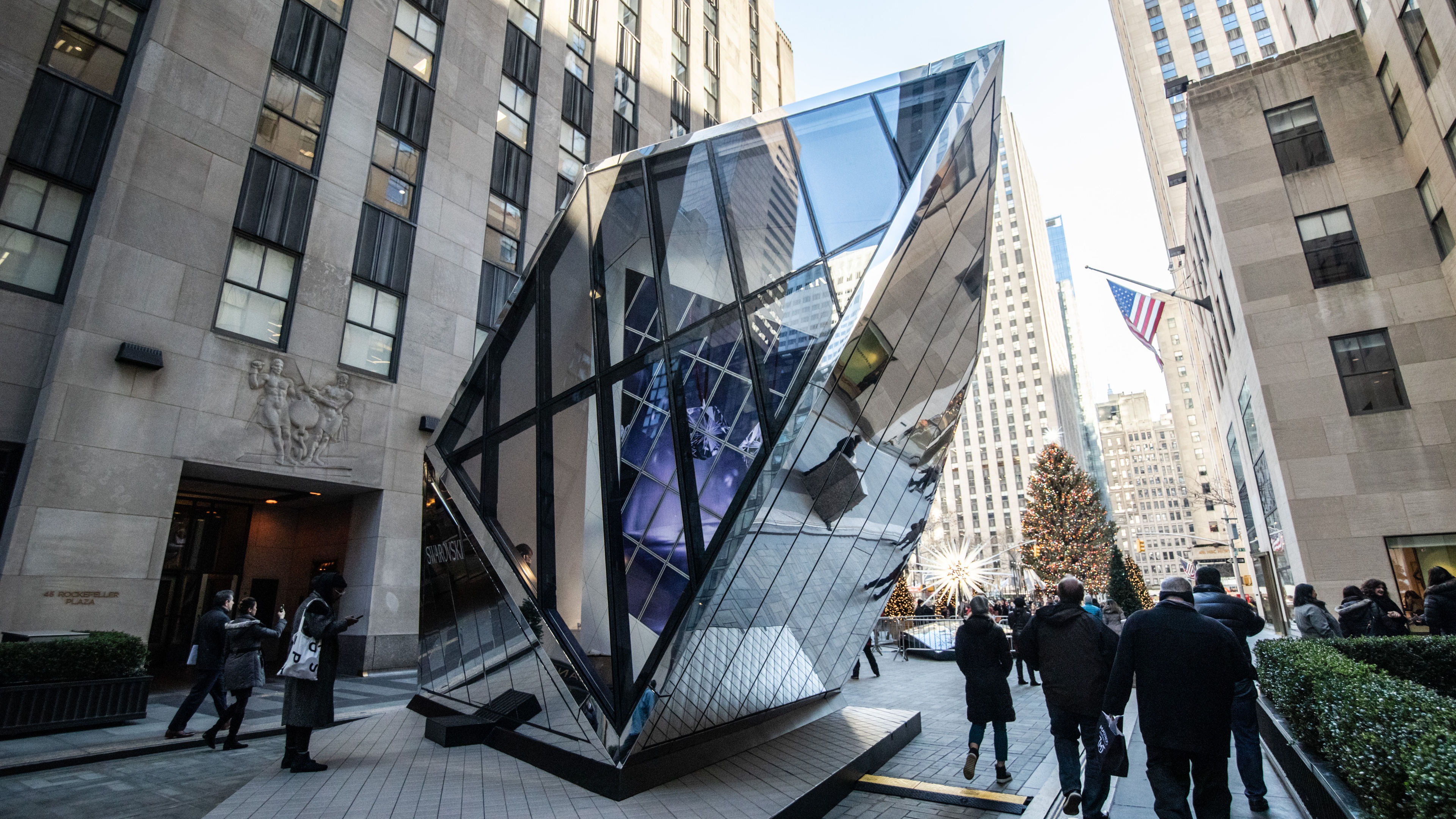 Swarovski glass pop up boutique in street with guests surrounding it