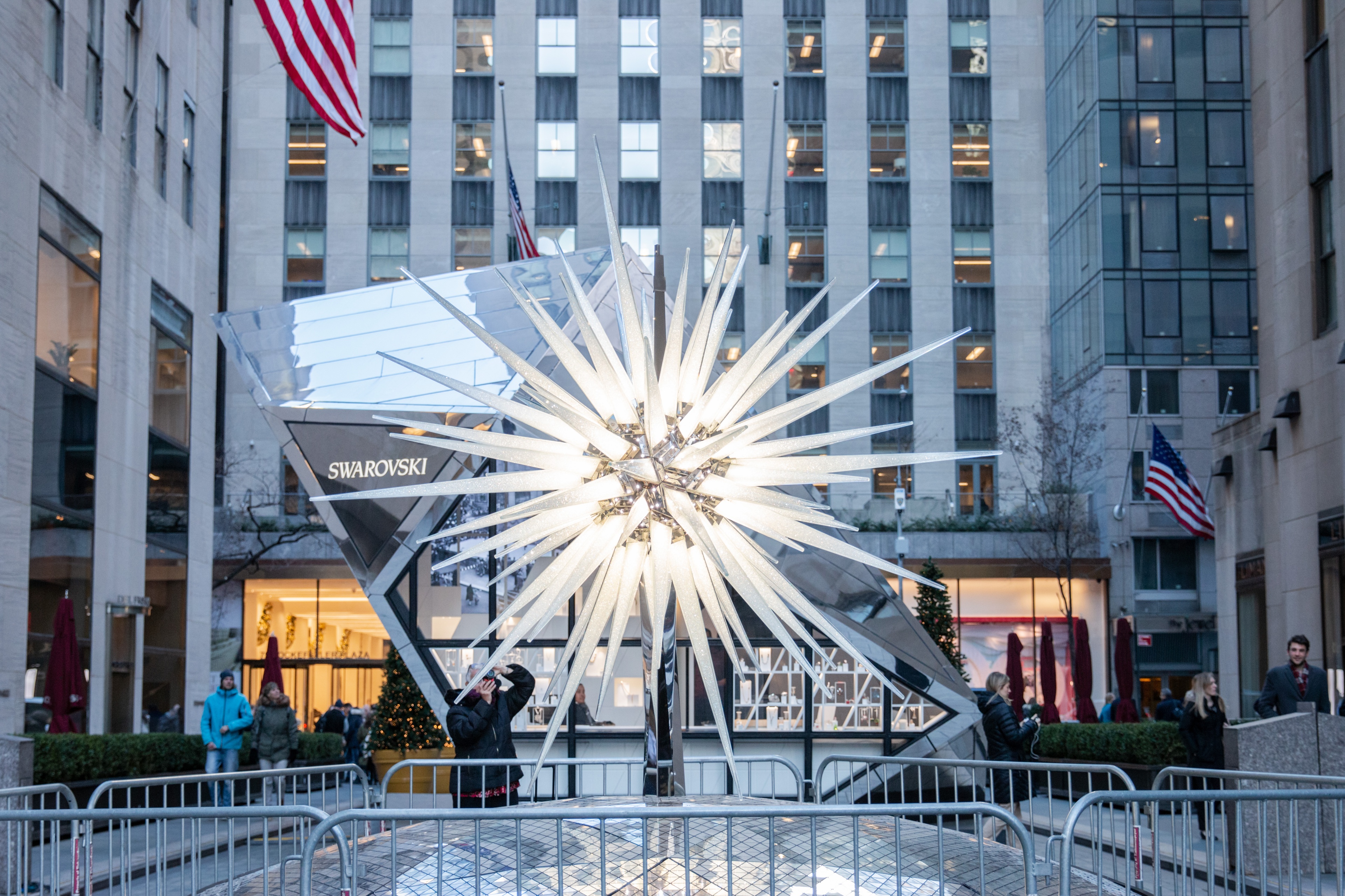 Swarovski crystal tree topper displayed in between buildings