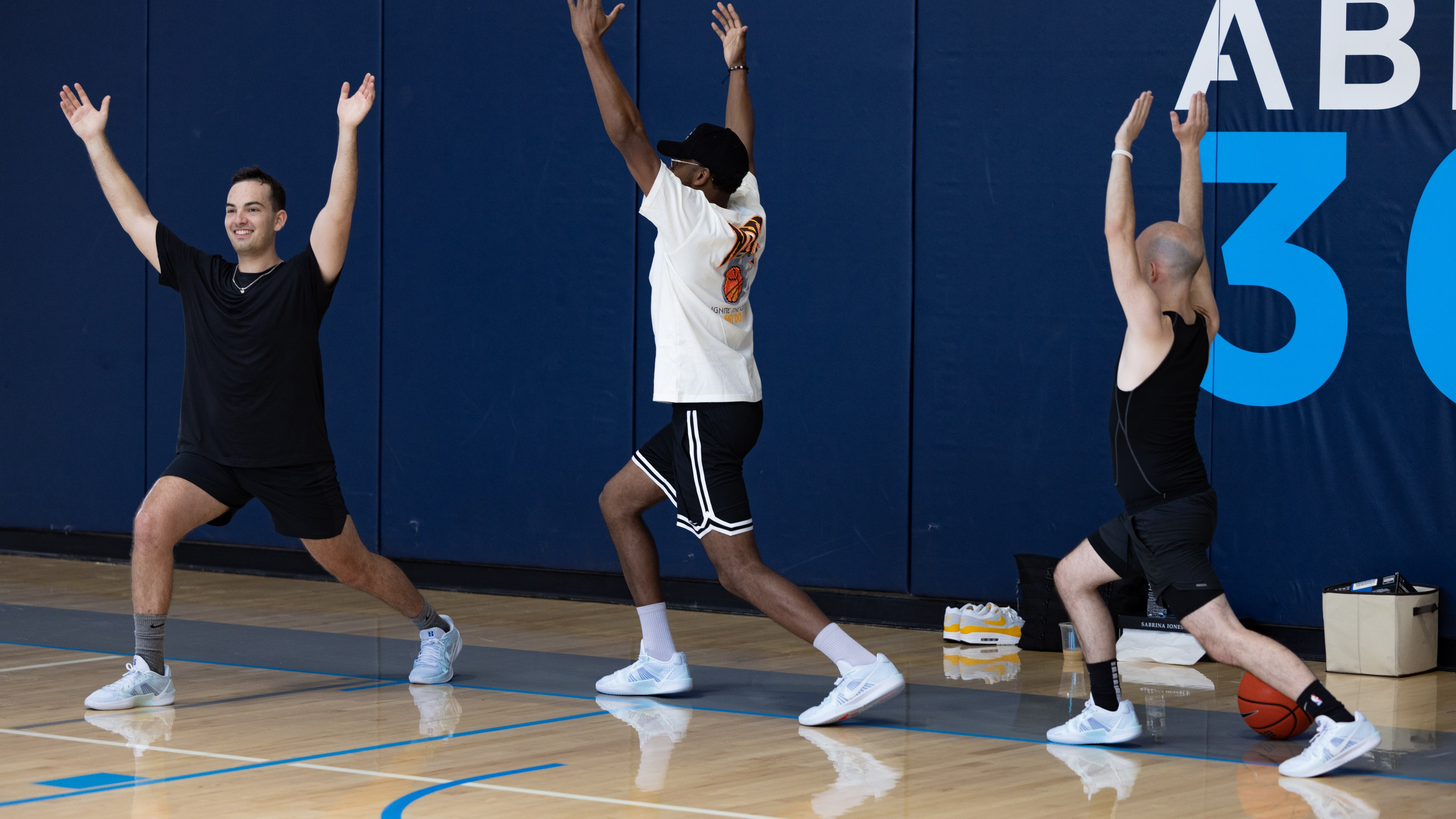 People stretching on basketball court