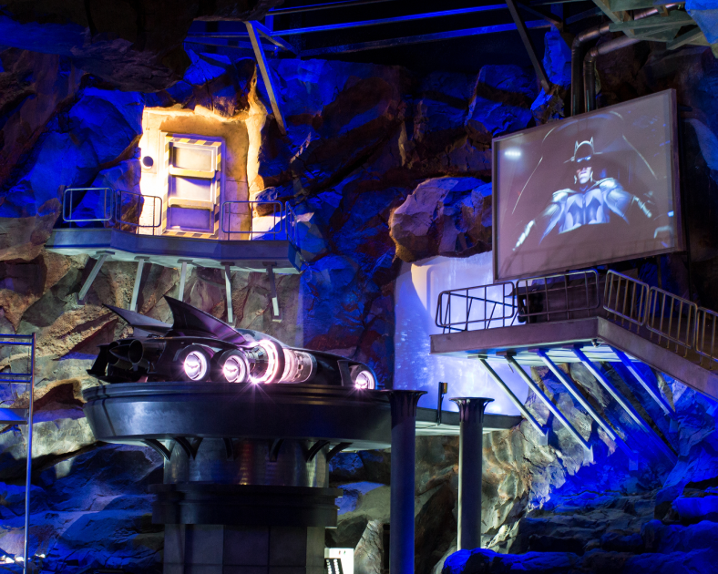 batmans cave with the batmobile on an elevated platform