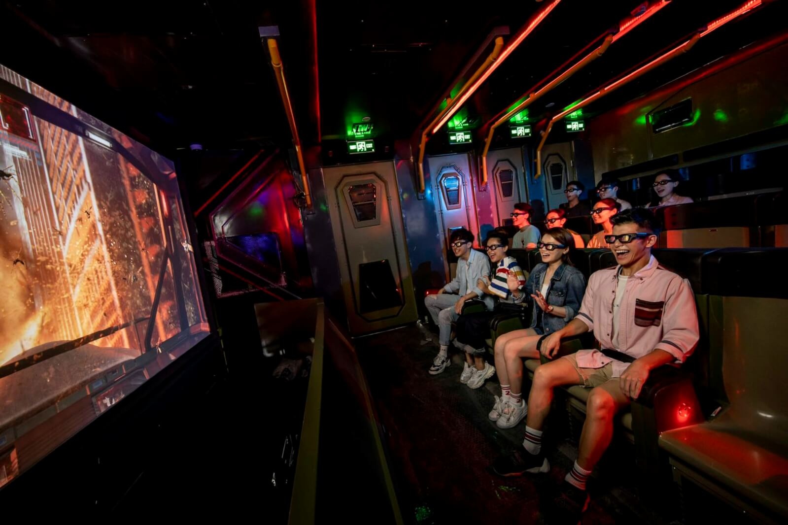 Children watching explosion on projector in futuristic cinema room with 3D glasses on
