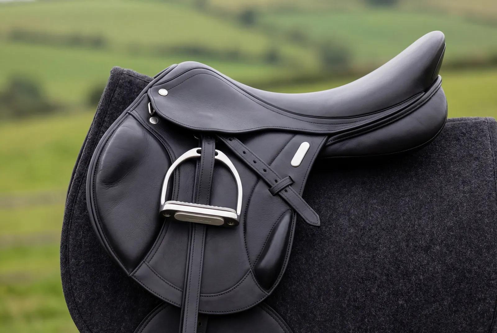An English saddle sitting on a horse’s back, checked for correct fit