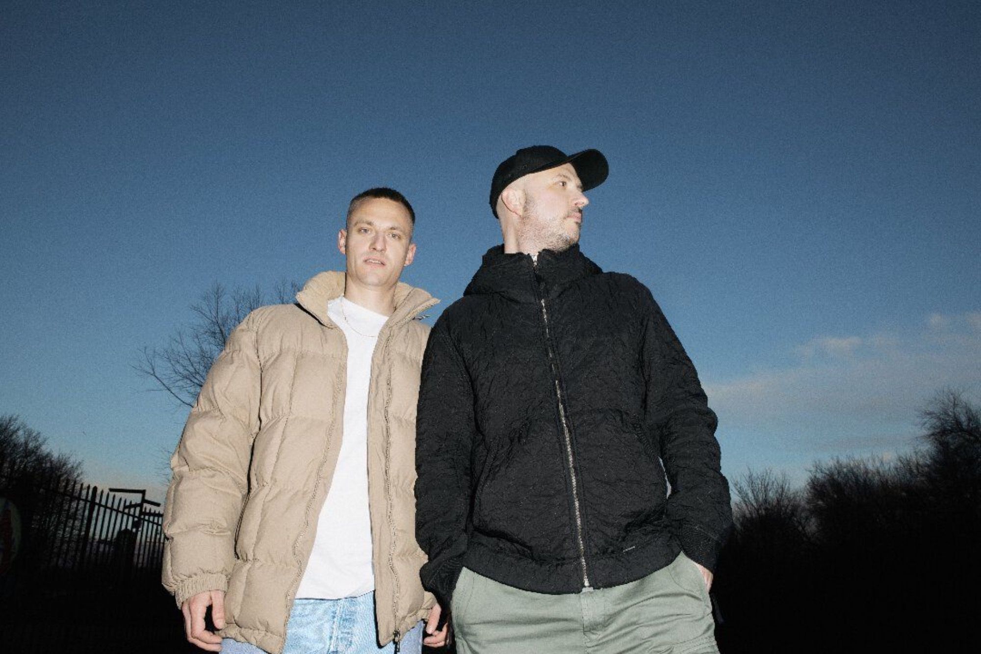 The duo, Overmono, in a park at night