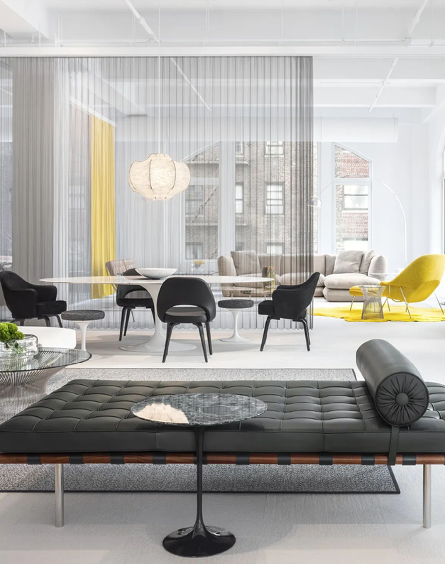 Bright office interior with pale furniture and yellow accent chairs