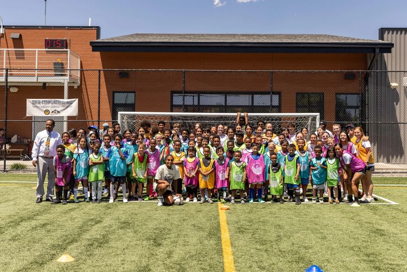 large group on soccer field posing for photo