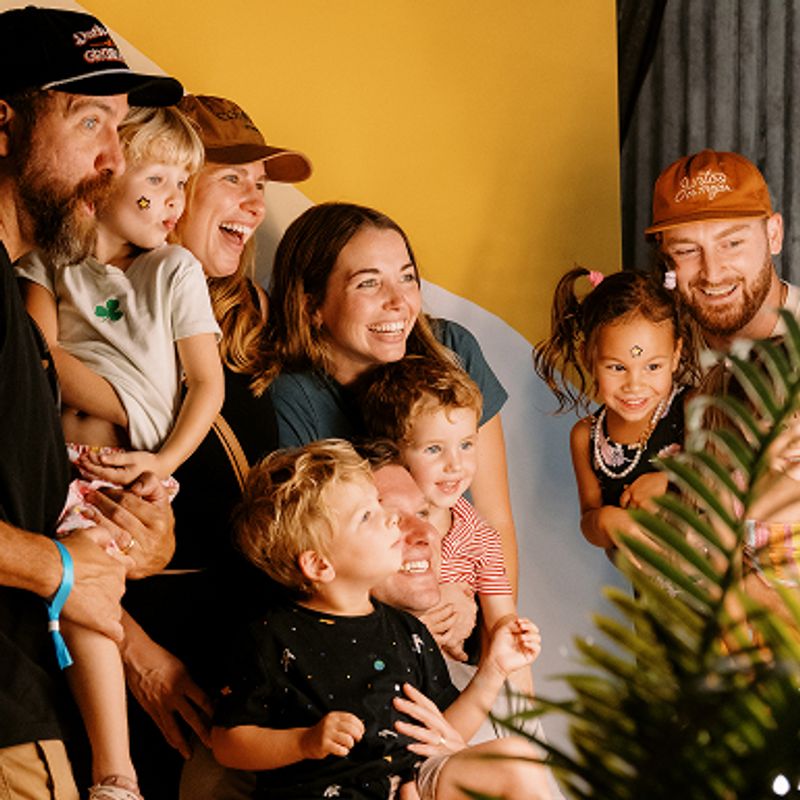 A young family smiling for a photograph.