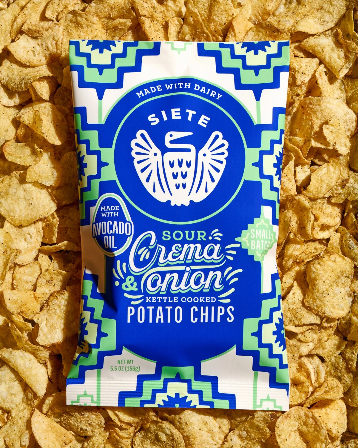 Sour crema and onion chips on background of chips