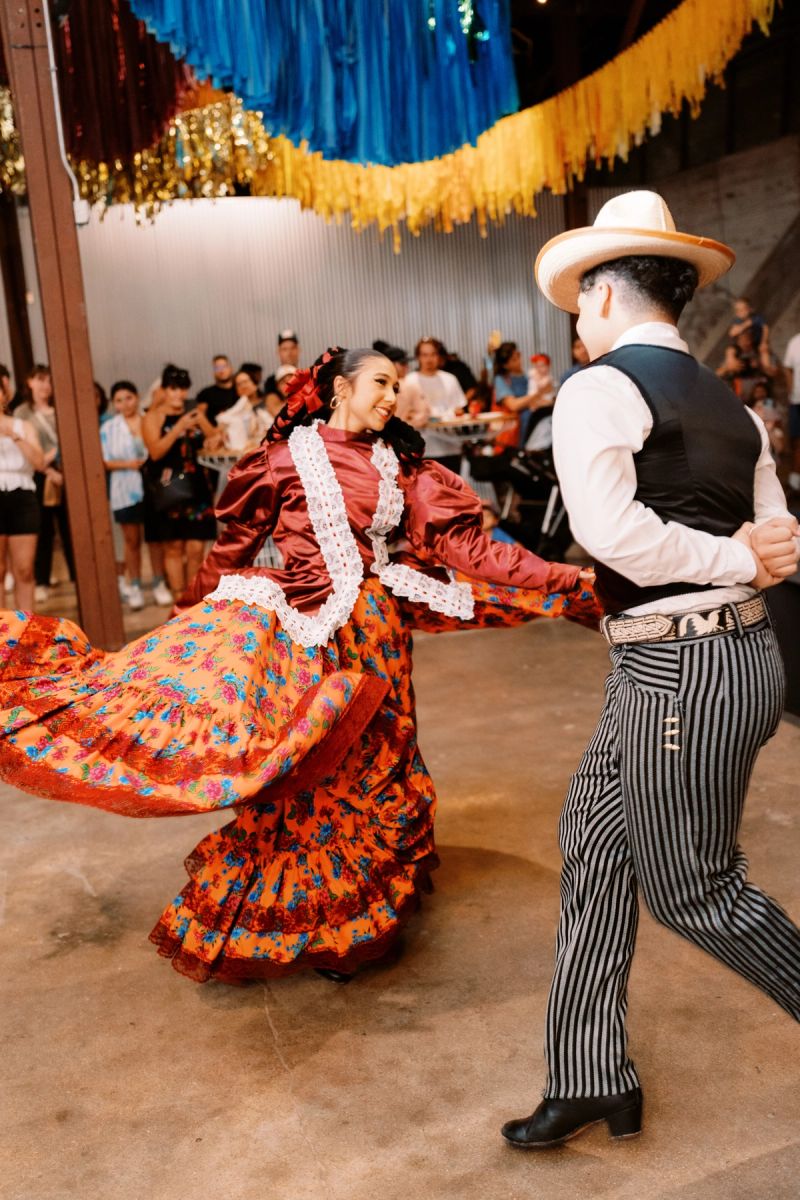 Two women dancing in traditional dresses.