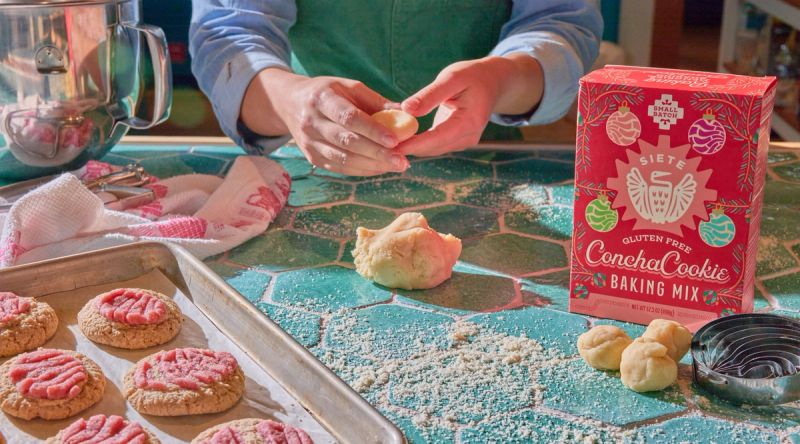 concha cookies on baking sheet, hand forming cookie with dough