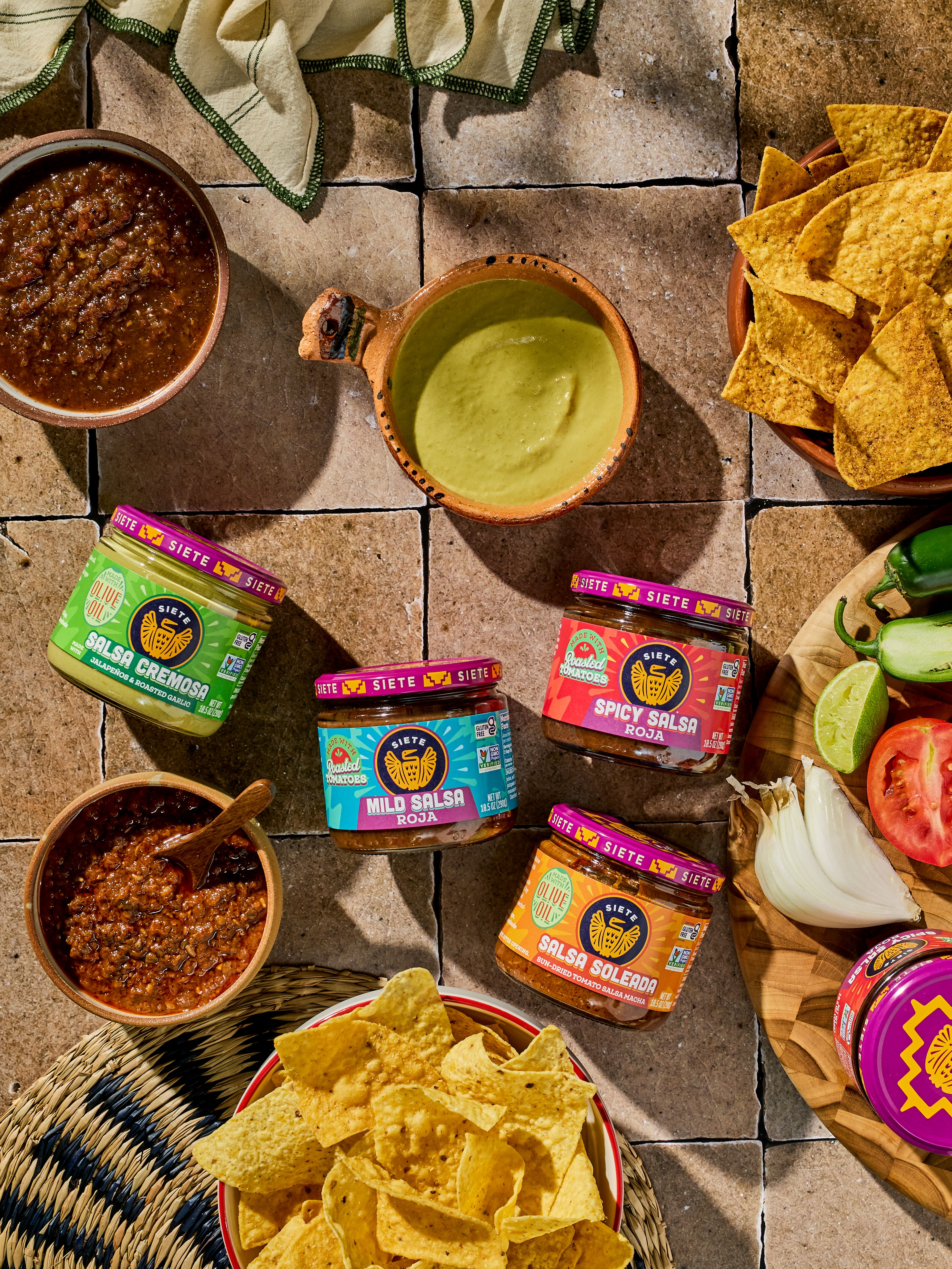 salsa jar laying flat with chips and salsa